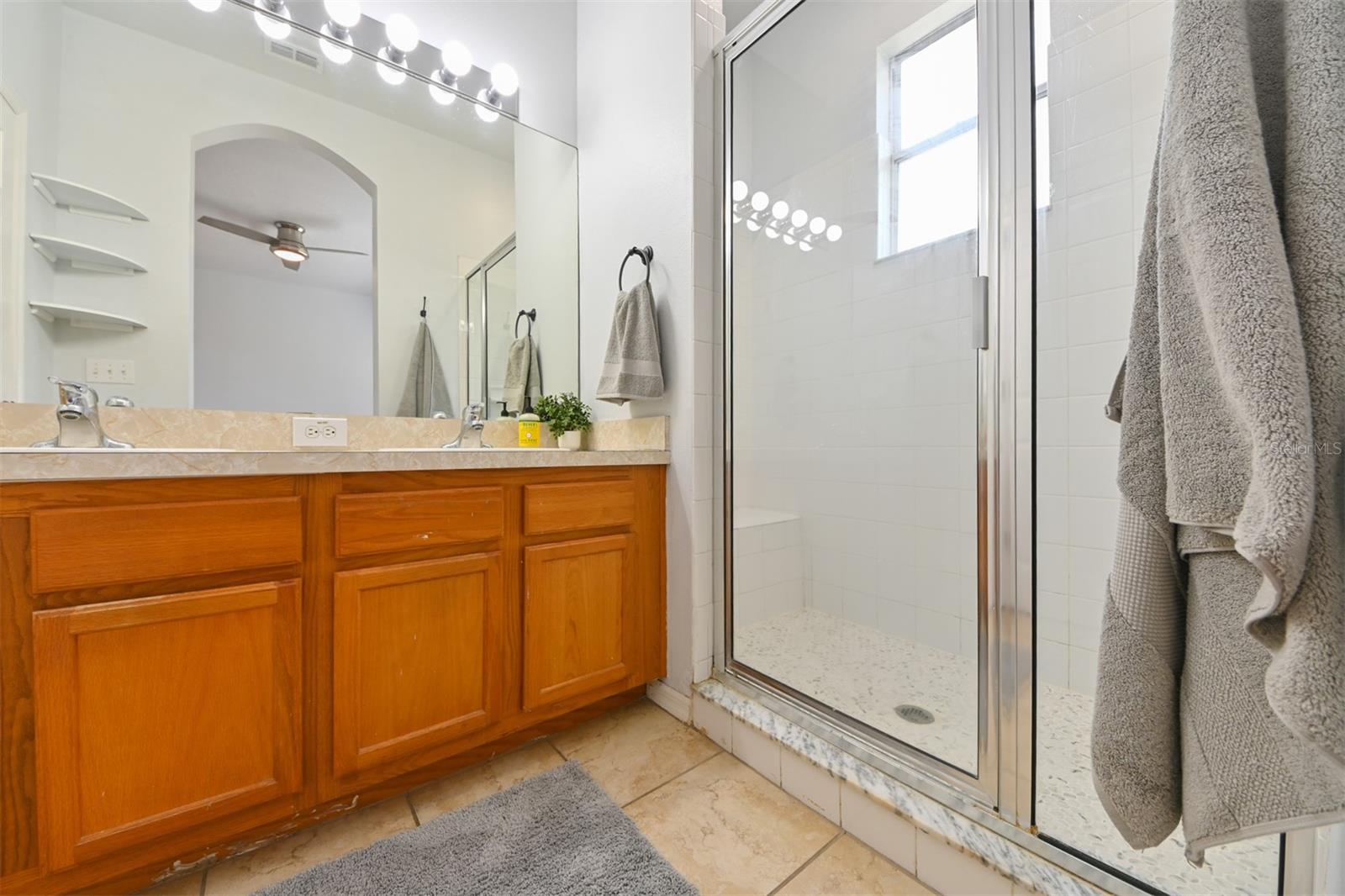 Primary Bathroom. Large Walk in shower with shower bench.