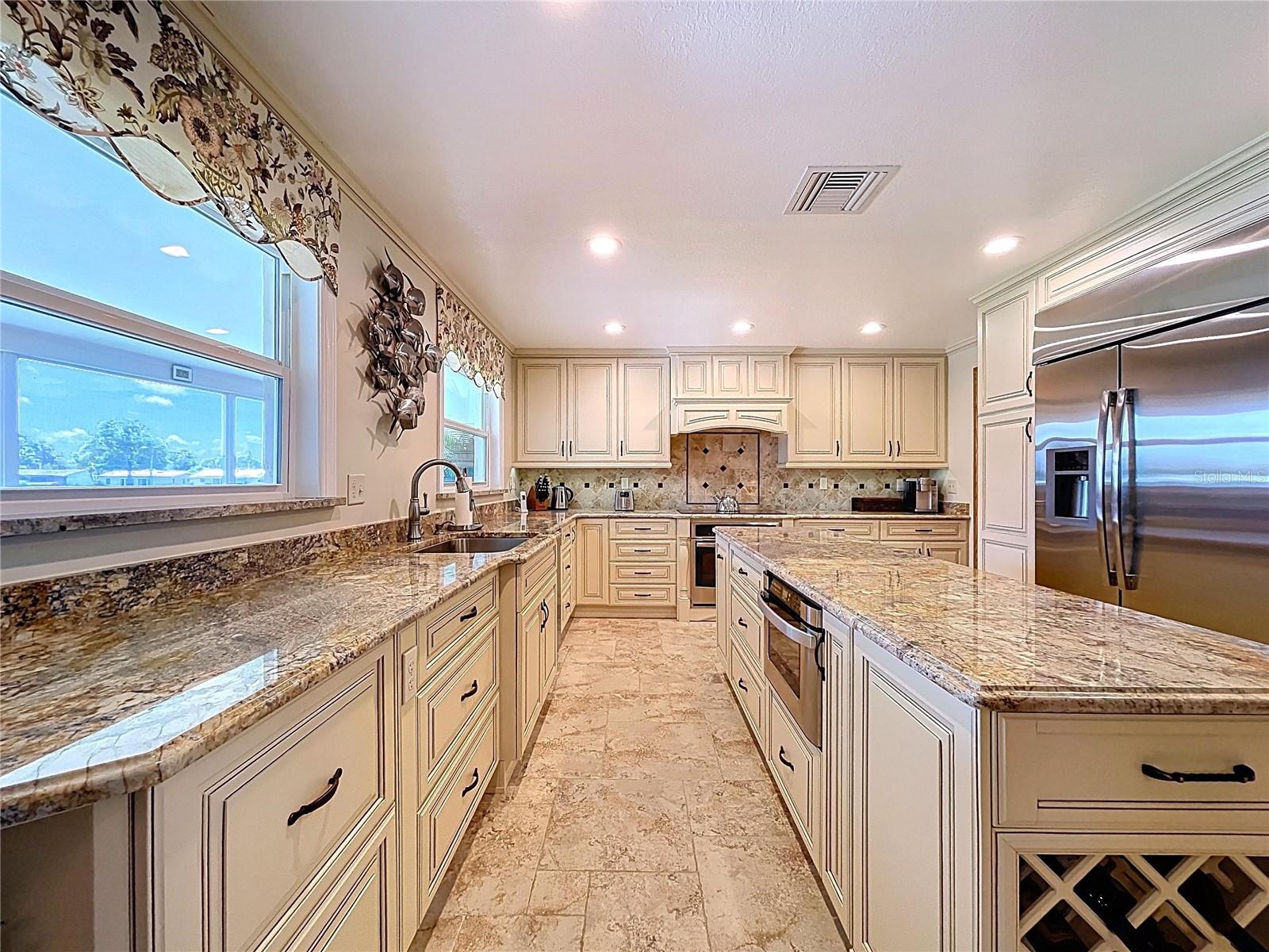So much granite counter space, perfect for large gatherings and prepping family dinners.