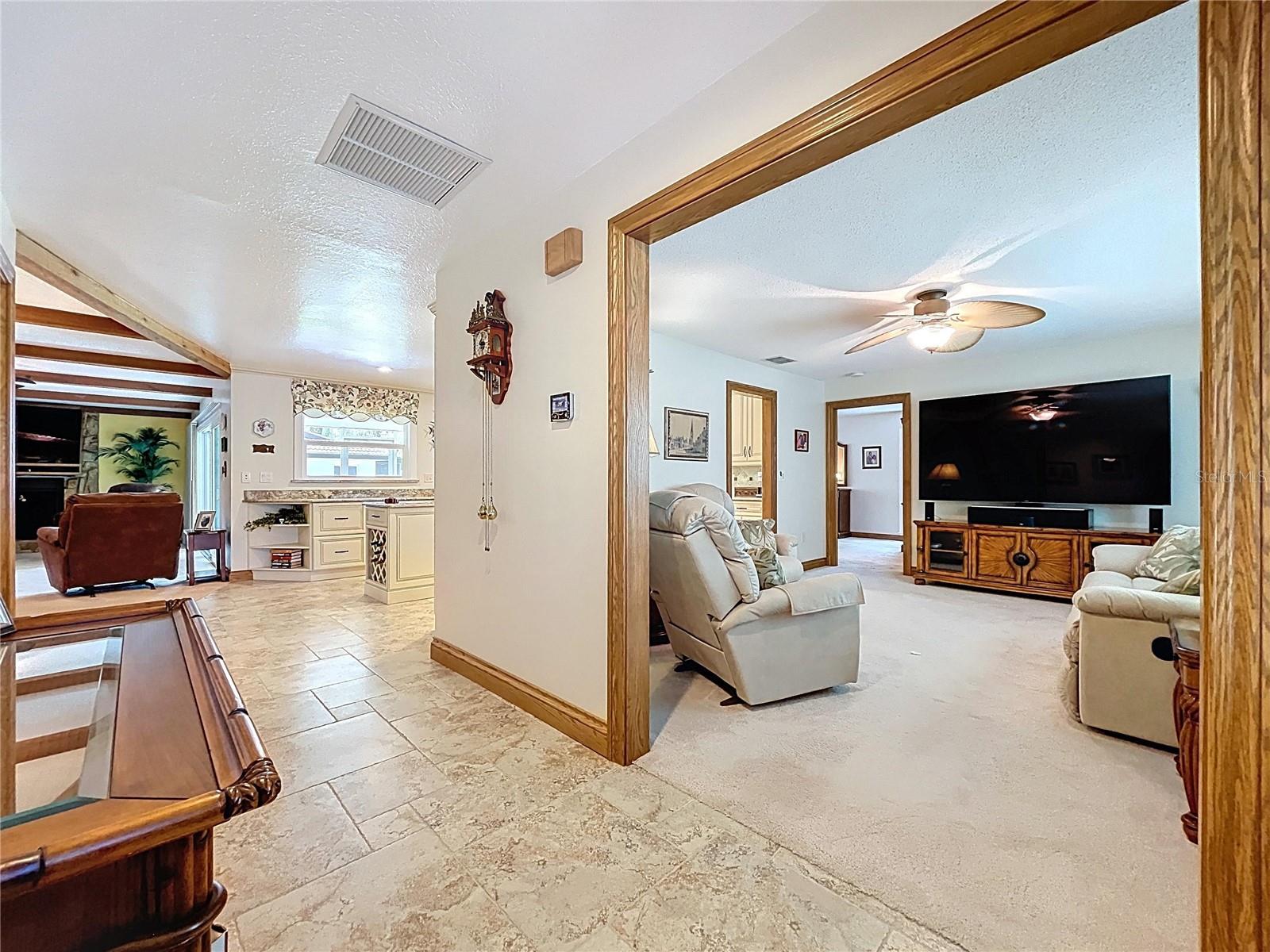 The foyer welcomes you into the formal living room to the right with the main family room and kitchen straight ahead.