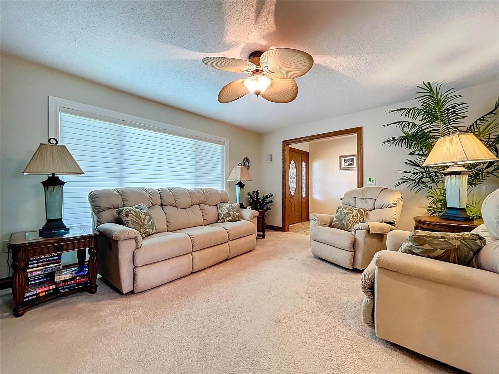 The spacious formal living room offers comfort and plenty of gathering space.