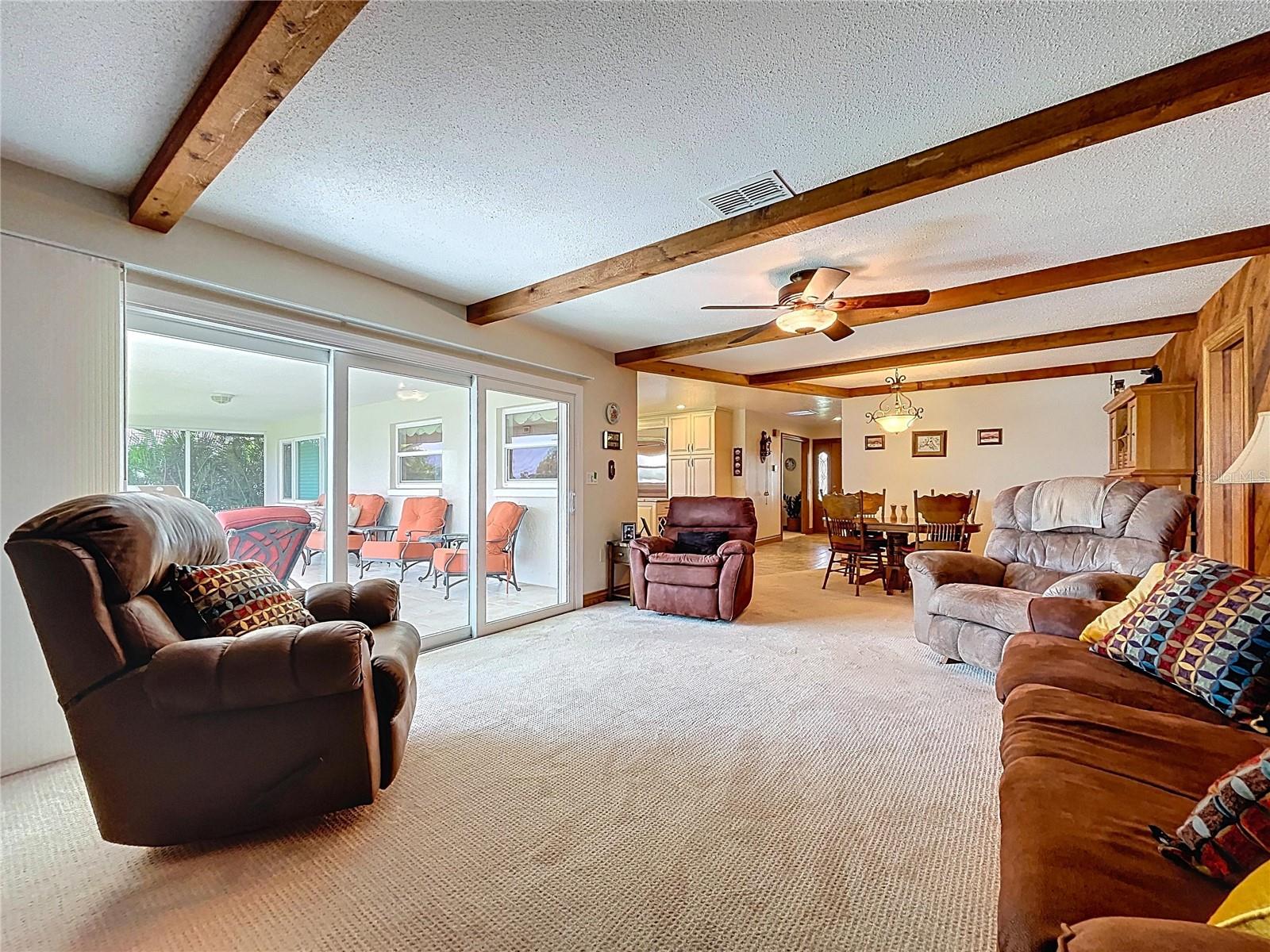 Natural light comes through the hurricane rated sliding doors and views of the lake from the Family room.
