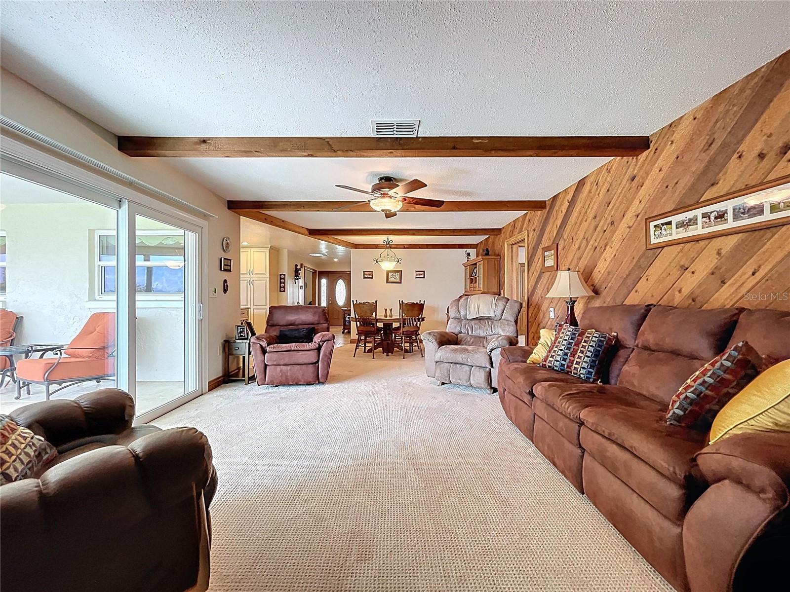 Natural light comes through the hurricane rated sliding doors and views of the lake from the Family room.