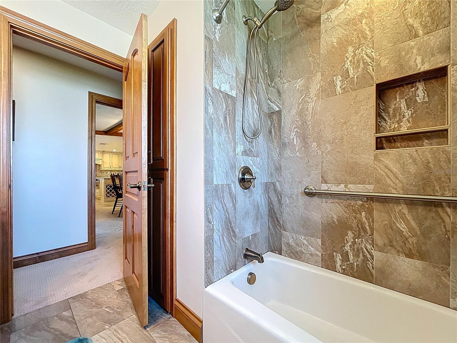 The updated guest bathroom is spotless and offers a shower with tub,