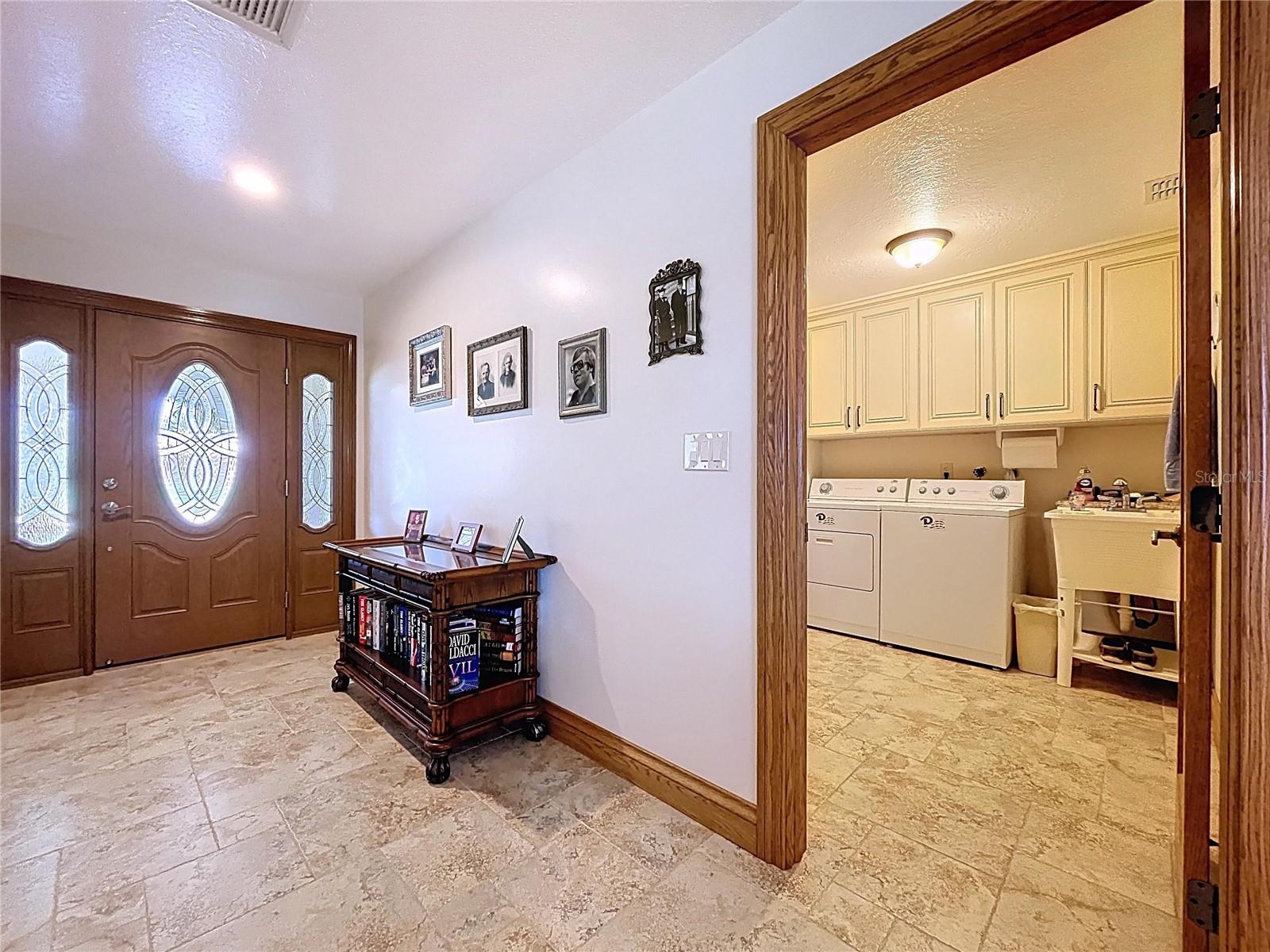 An inside laundry room is a MUST-HAVE in Florida!  This large laundry room offers plenty of storage space as well as a utility sink.