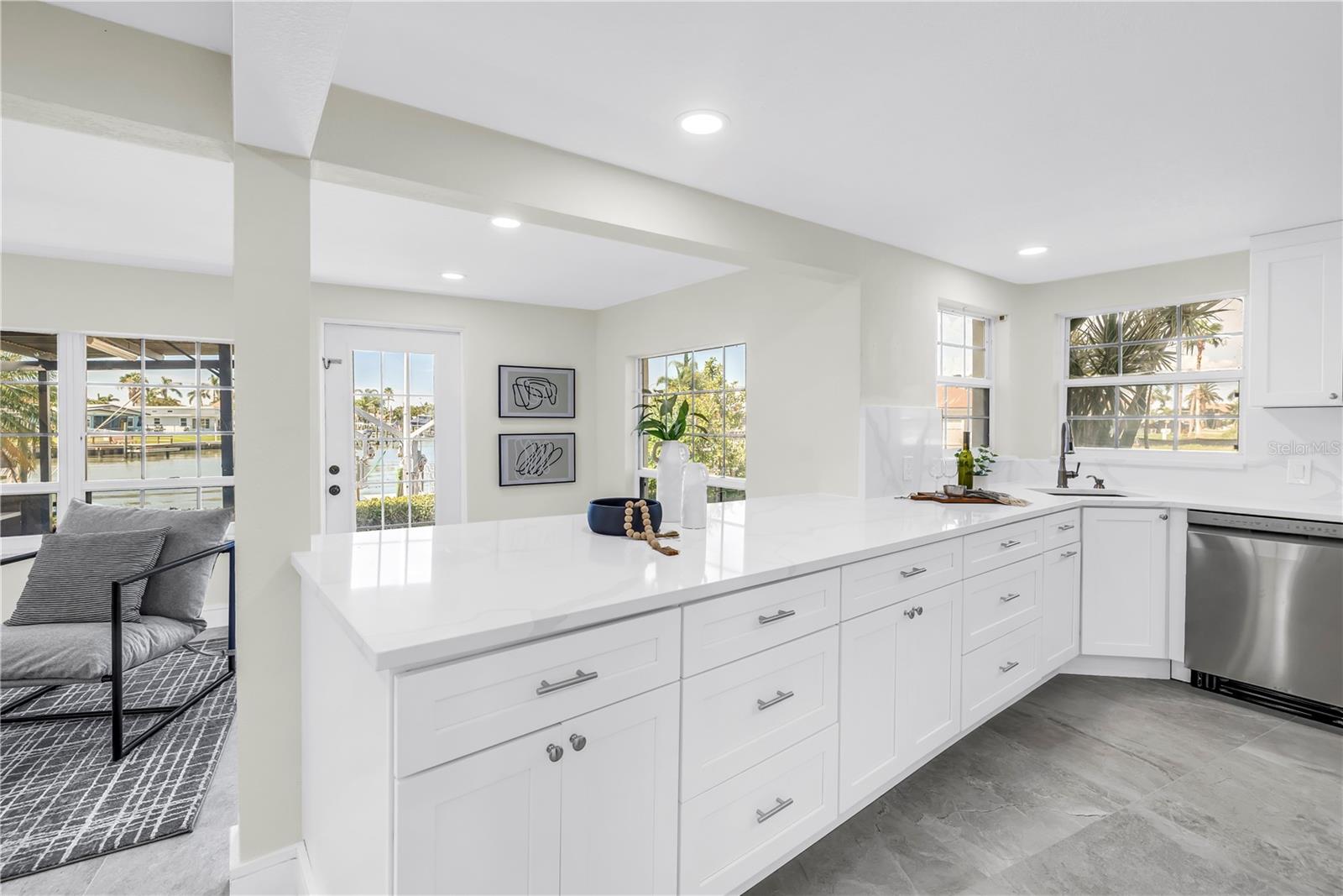Elegant kitchen offers marble counter tops.