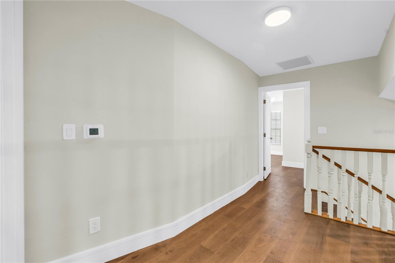 Upper level landing offers space for a sitting area.