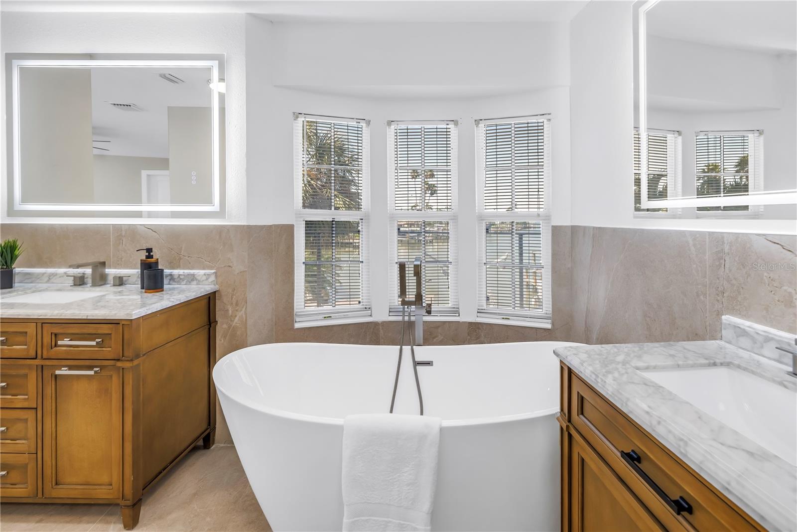 Enjoy water views while soaking in the elegant tub.