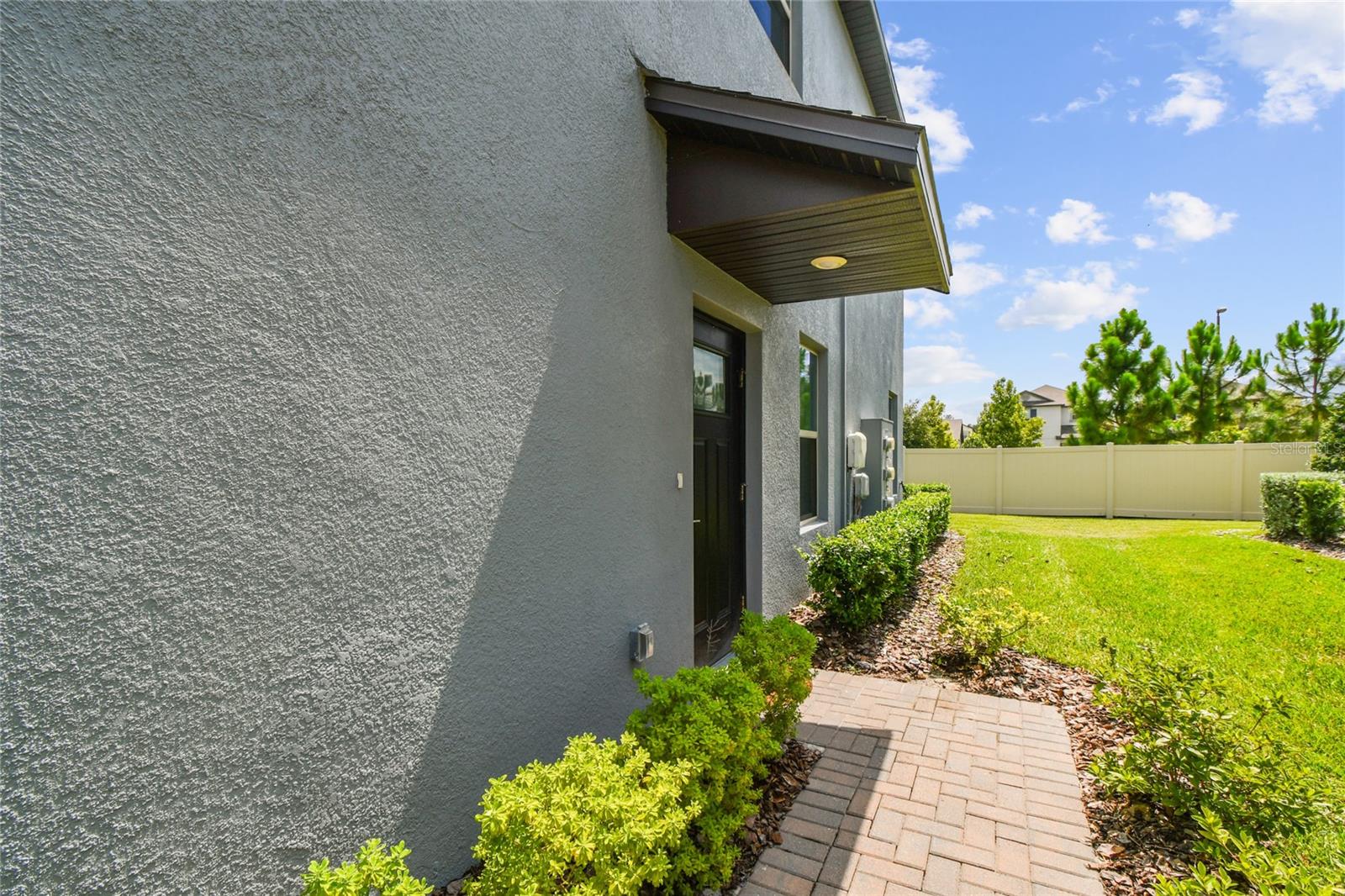 side entrance with paver walkway