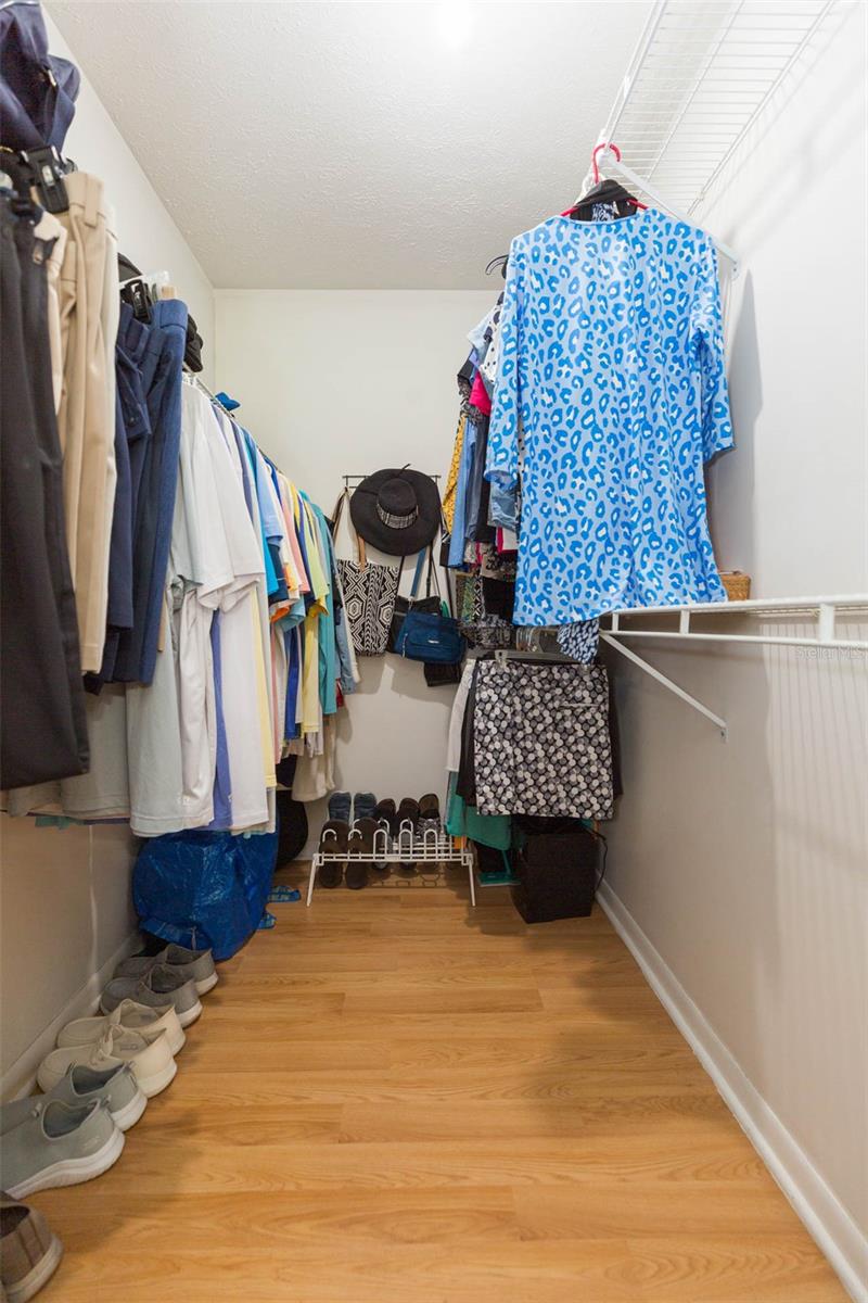 Primary bedroom walk in closet