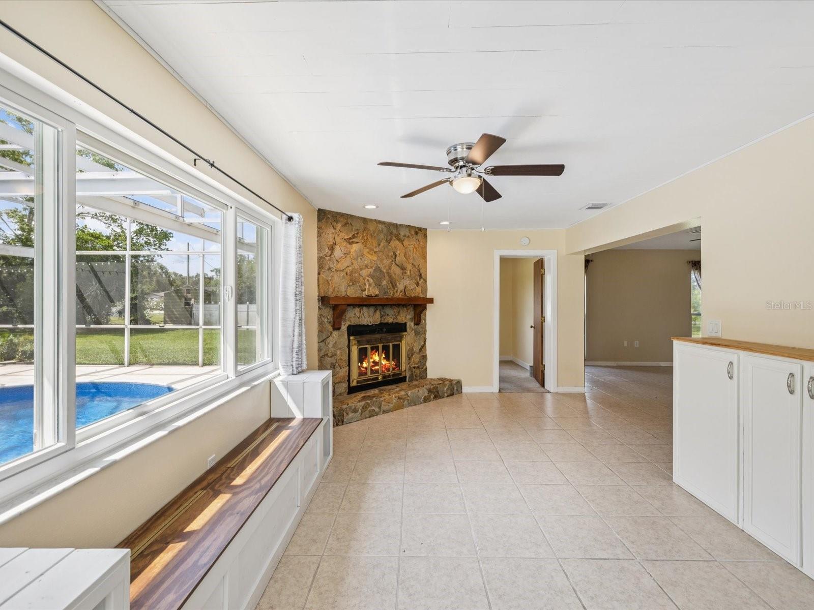 Stone wood-burning fireplace with a custom mantle for cozy evenings