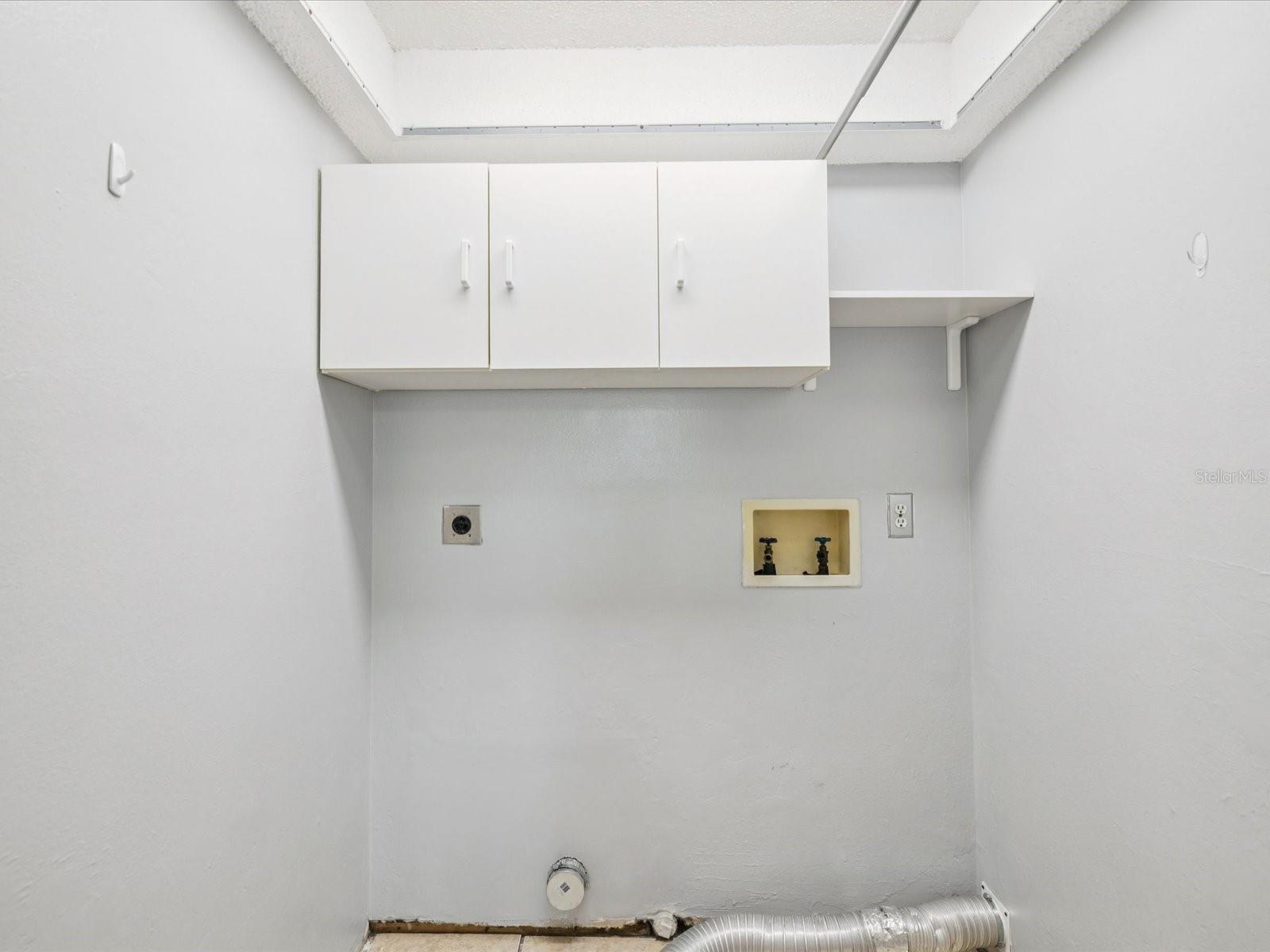 Indoor laundry with hookups for electric washer and dryer