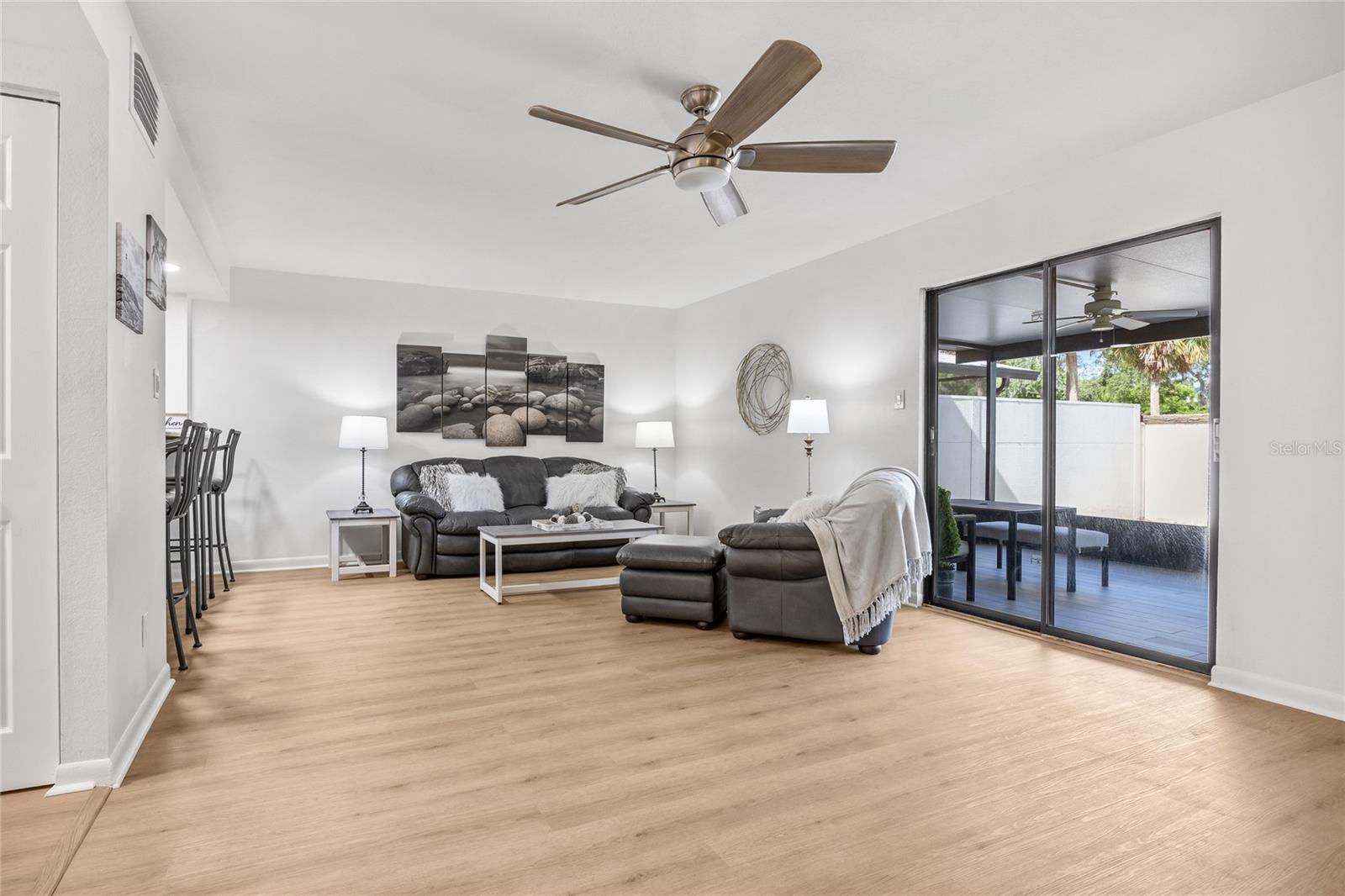 Alternate view in the Great Room showing the sliding glass doors to your screened and covered lanai.