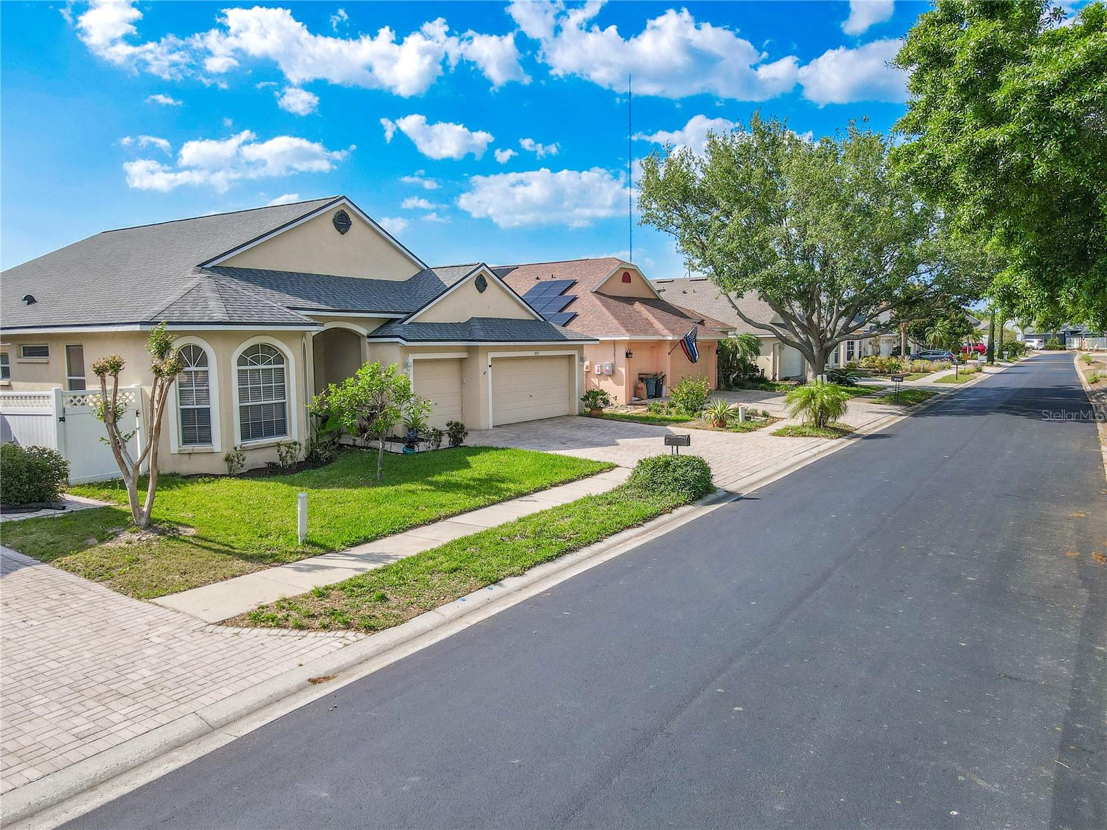 Curb appeal abounds with a pavered driveway, arched windows, and a charming covered entryway that sets a warm, welcoming tone.