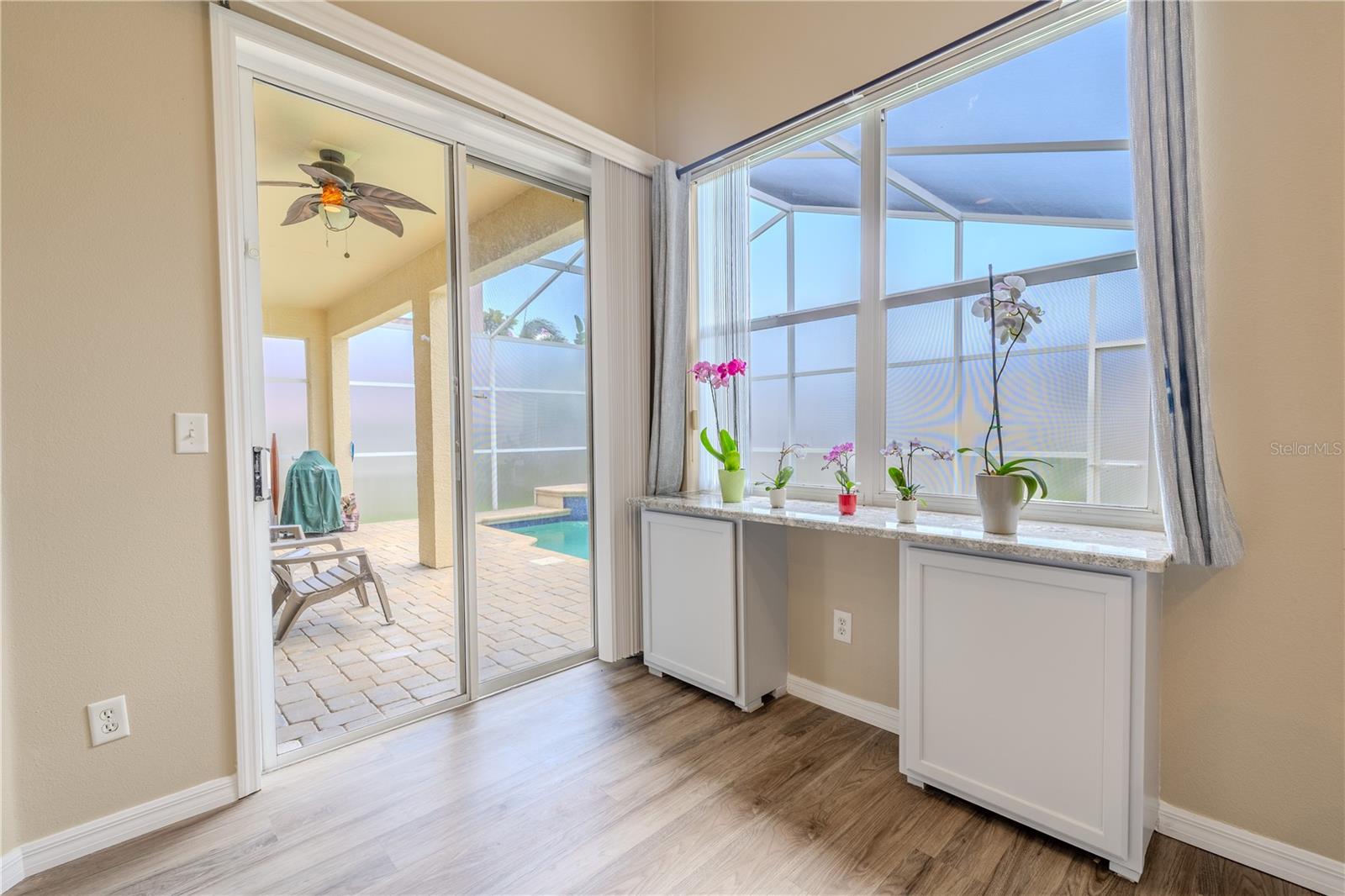 Large windows and another set of sliders keep the family room light and breezy while connecting indoor living to the outdoor oasis.