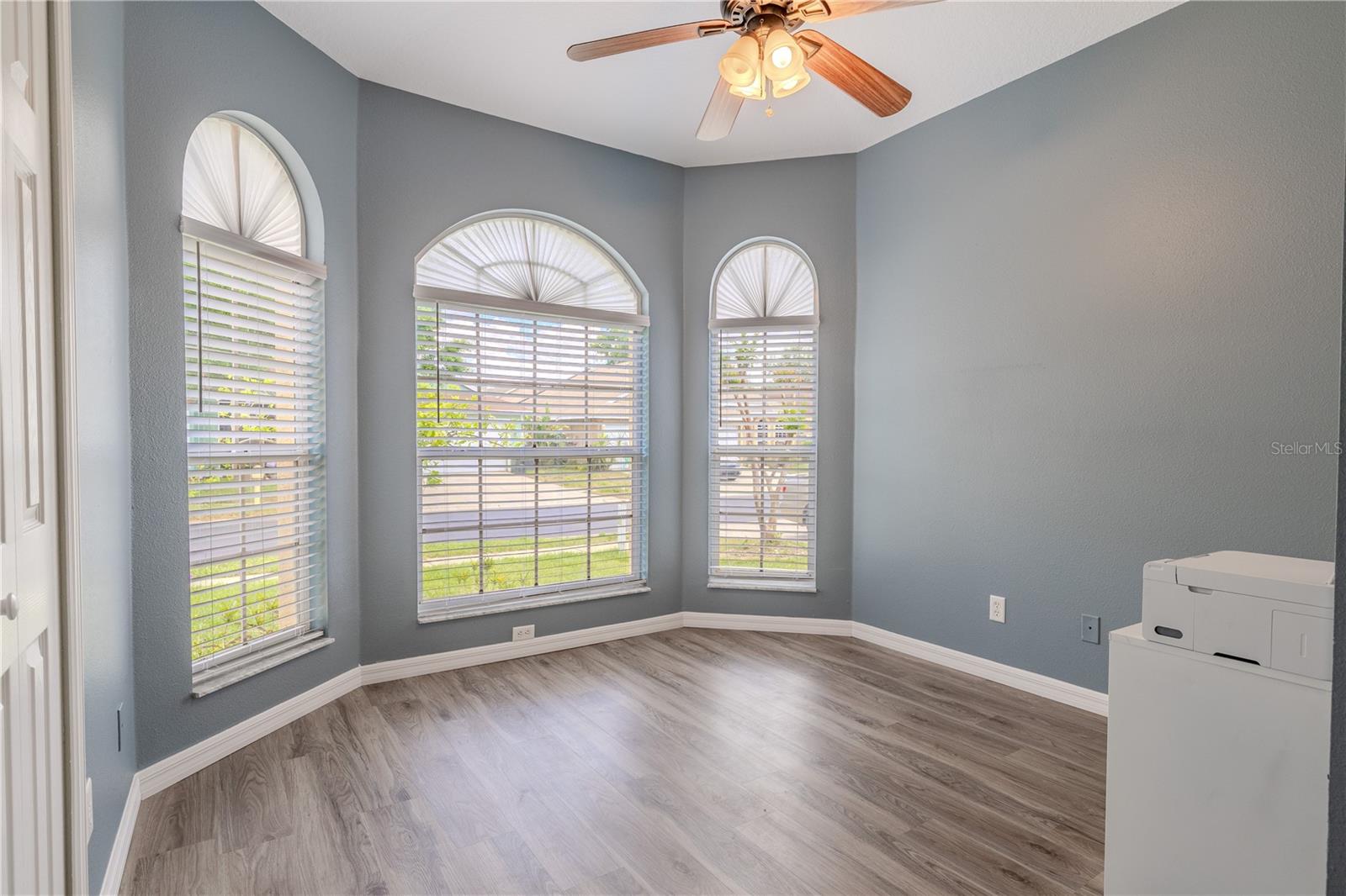 Bedroom 4 connects to the primary suite, making it perfect for a nursery, home office, or private retreat. The versatile fourth bedroom shines with natural light streaming through a trio of arched windows with elegant fanlights.