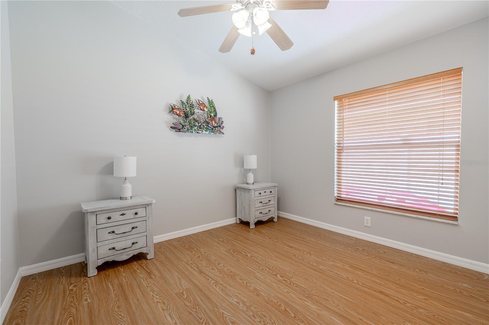 Bedrooms 2 and 3 also feature vinyl floors, built-in closets, and ceiling fans with light kits.