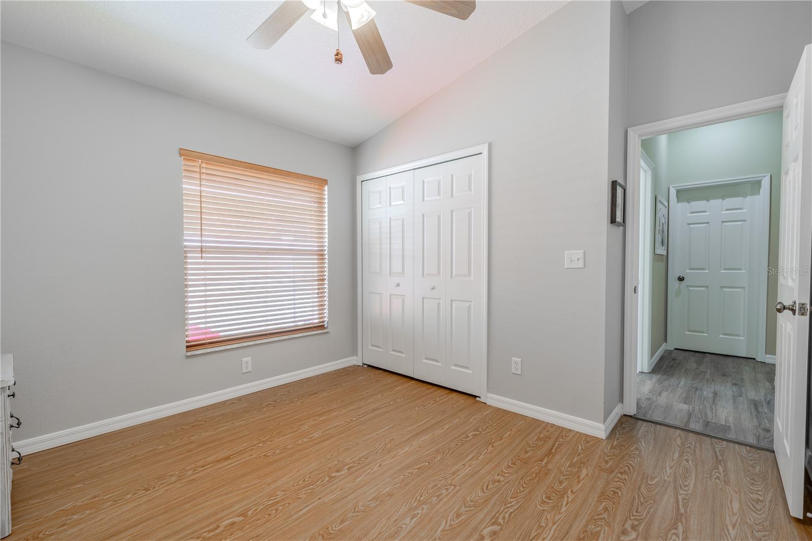 Bedrooms 2 and 3 also feature vinyl floors, built-in closets, and ceiling fans with light kits.
