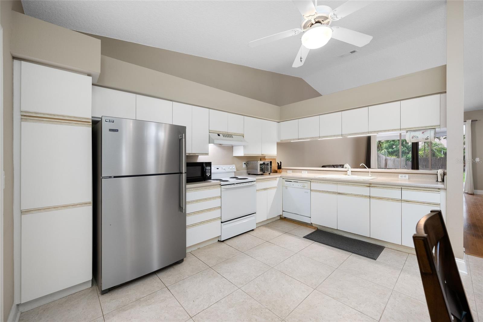 Light-Filled White Kitchen — Enjoy a Clean, Airy Feel in the Bright White Kitchen at 3005 Pepperwood Ln W, Perfect for Cooking and Entertaining.
