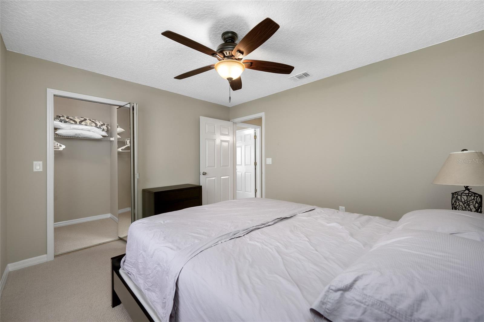 Light-Filled Second Bedroom — 3005 Pepperwood Ln W Features a Private Second Bedroom with Ample Closet Space and Natural Light.