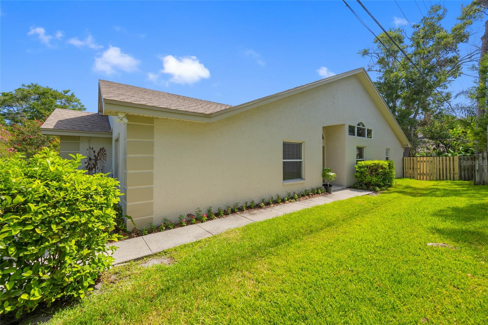 Private Side Yard & Inviting Entry — Gated Walkway Leading to the Front Door at 3005 Pepperwood Ln W, 3005 Pepperwood Ln W Offering Both Privacy and Curb Appeal
