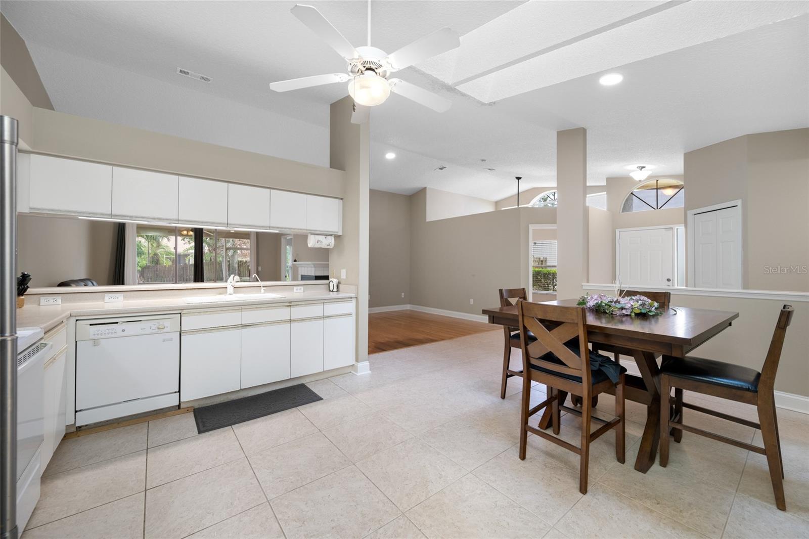 Sleek & Inviting Kitchen — 3005 Pepperwood Ln W Offers a Bright White Kitchen with Updated Finishes, Open Layout, and Sunlit Dining Space.