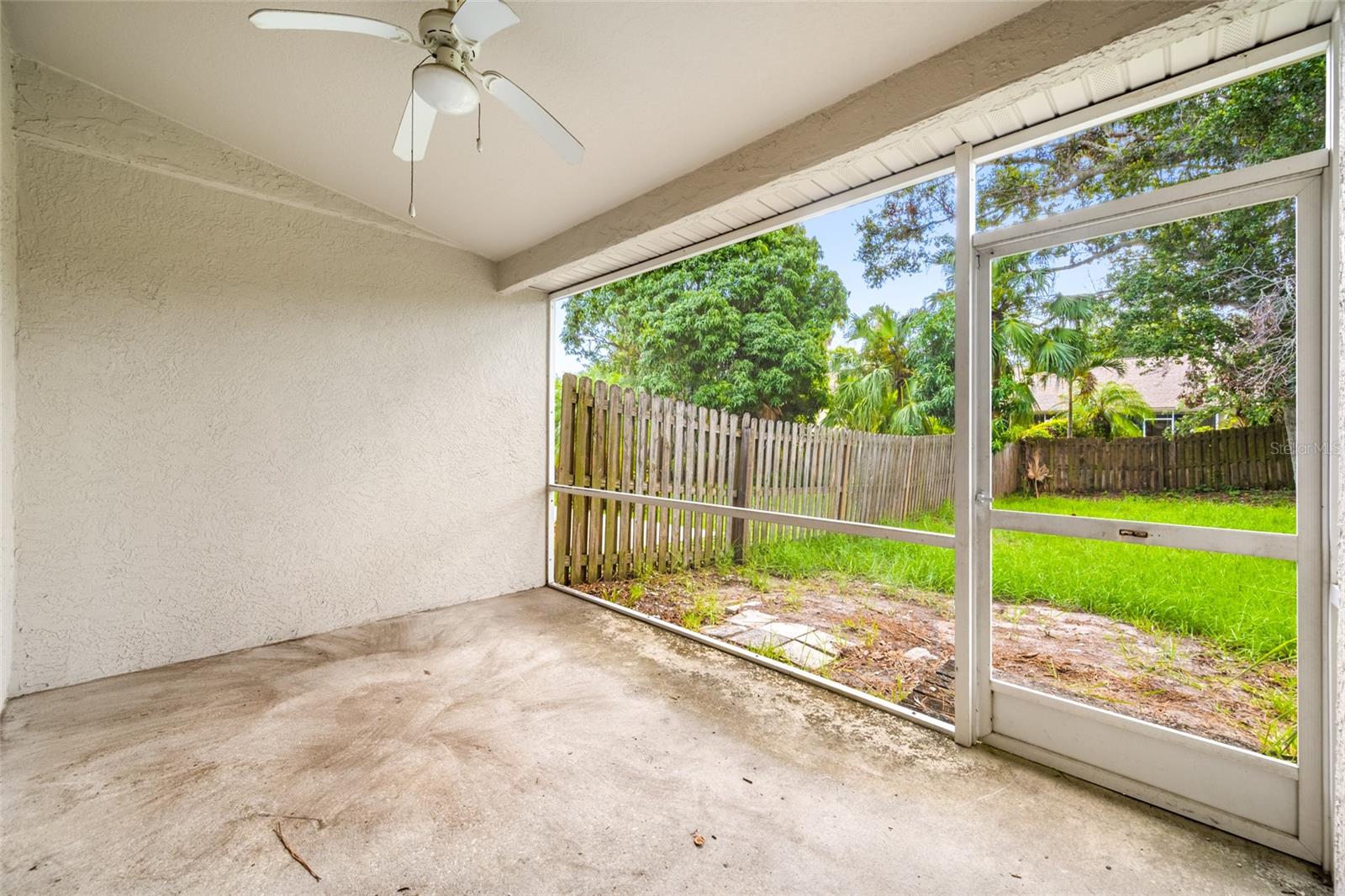 Tranquil Screened Patio — 3005 Pepperwood Ln W Offers a Peaceful, Covered Outdoor Retreat Overlooking the Fenced Backyard
