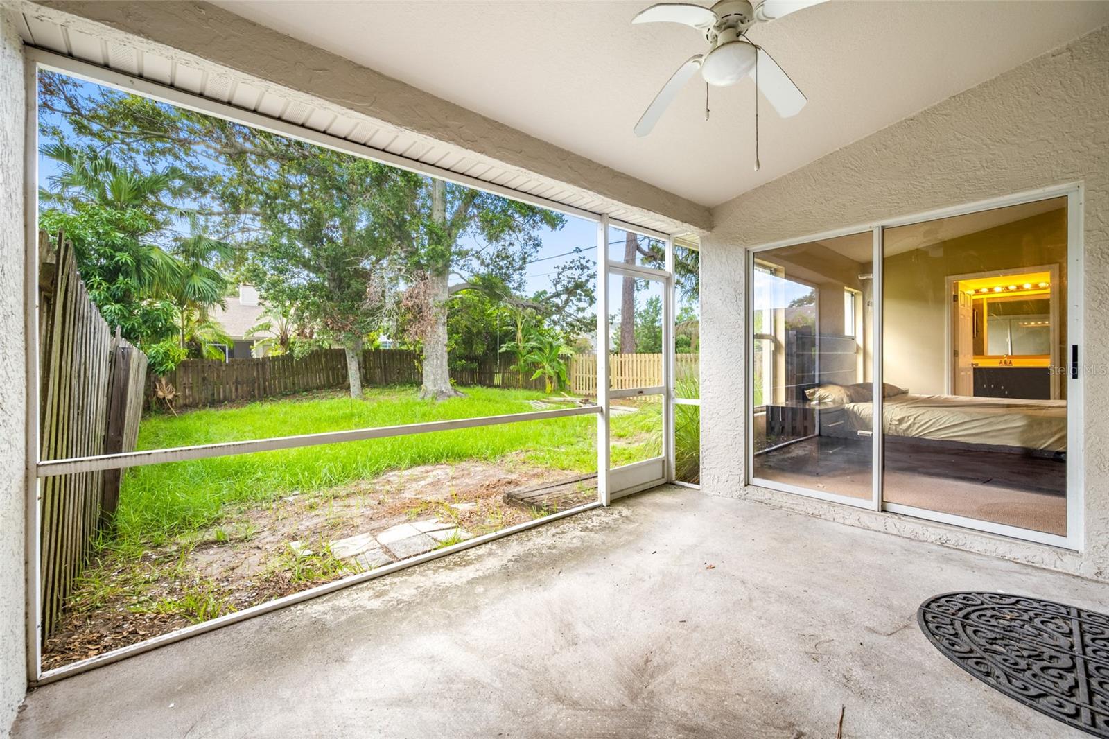 Indoor-Outdoor Living — Enjoy Year-Round Comfort in the Spacious Screened-In Patio at 3005 Pepperwood Ln W, Ideal for Entertaining or Quiet Relaxation