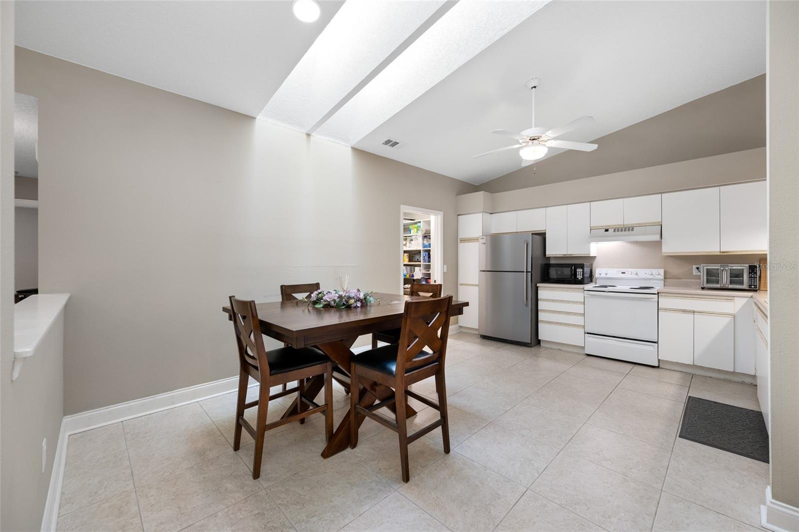 Stylish Kitchen Dining — Enjoy Everyday Gatherings in the Light-Filled Eat-In Kitchen at 3005 Pepperwood Ln W, Blending Function and Comfort.
