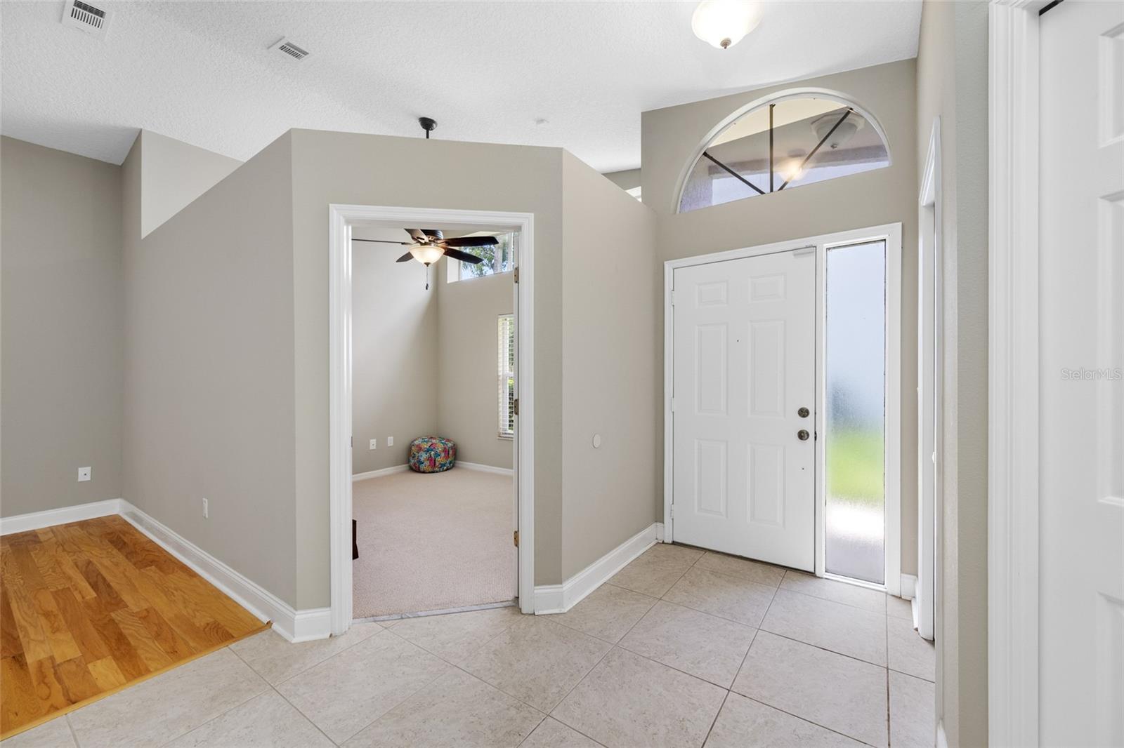 Elegant Entryway — 3005 Pepperwood Ln W Features a Spacious Interior Entrance with Soaring Ceilings and Natural Light, Offering a Warm First Impression.