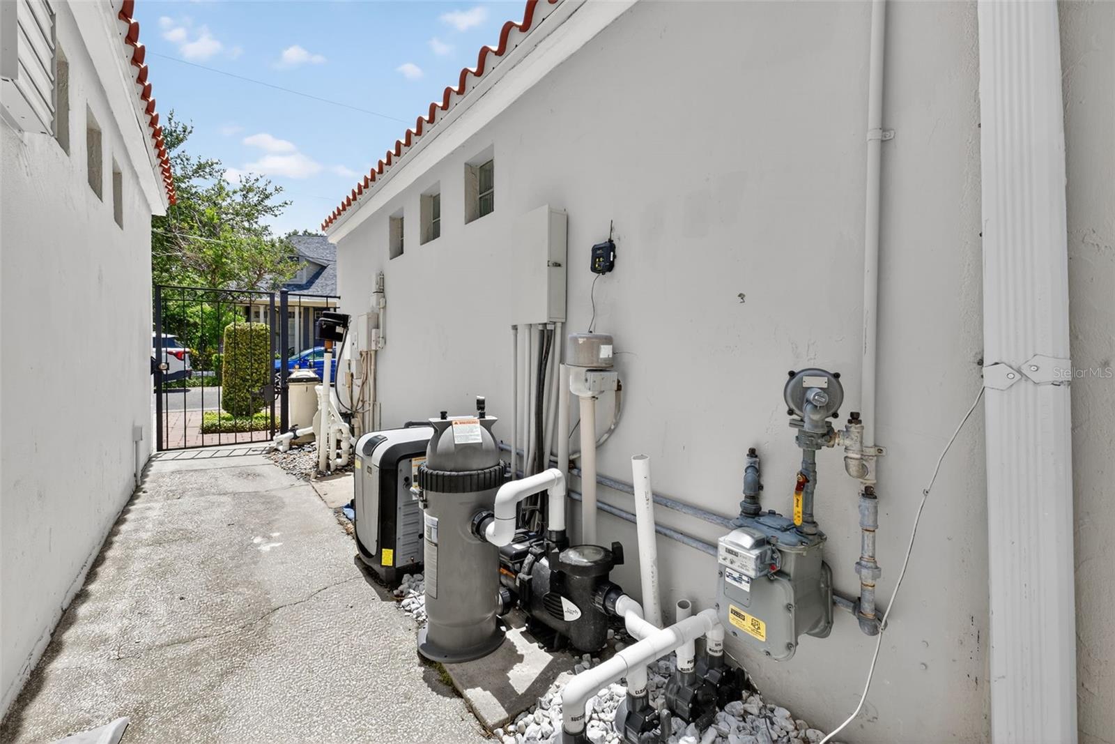 Private gate for pool equipment on side of unattached condo. No common wall.