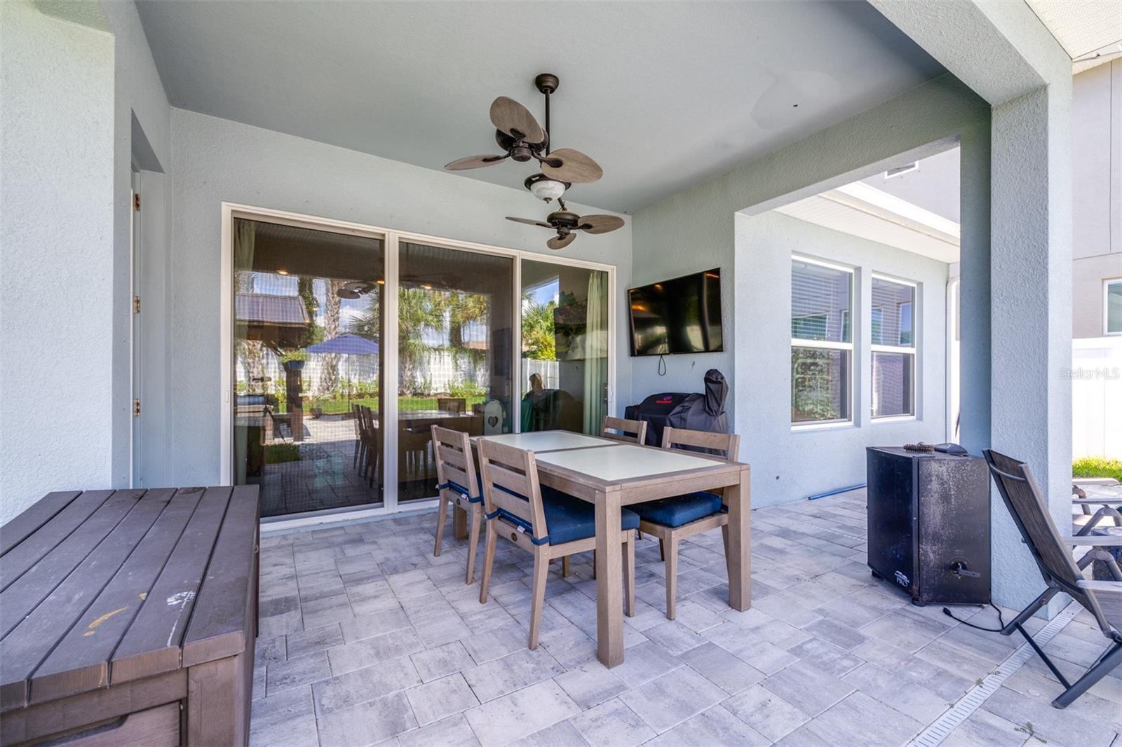 sliders from family room opens fully to the outdoor paved patio
