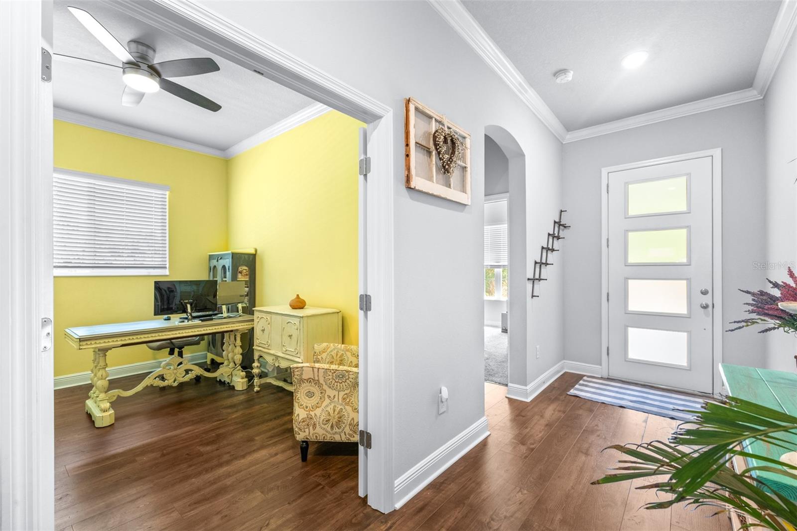 archway into guest bed/bath and office of main hall with glass french doors (not seen in photo)