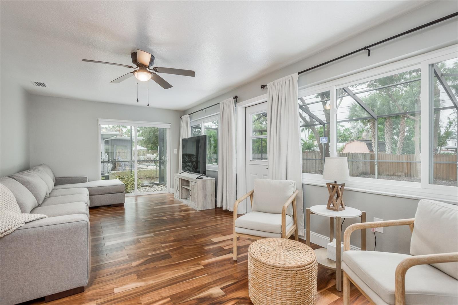 Living room with slider to the back pool area. Lots of natural lighting.
