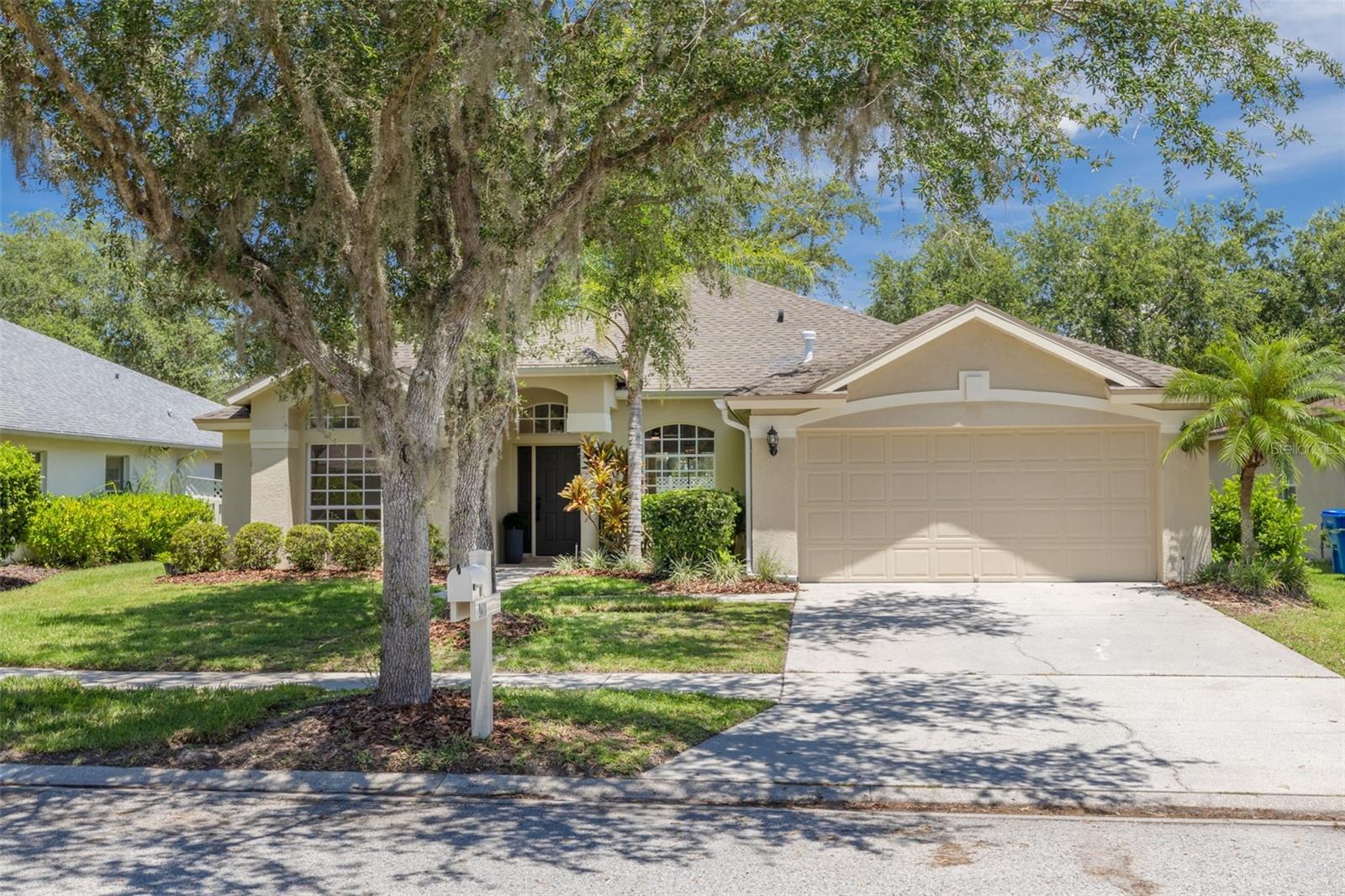 Nestled under the shade of magnificent mature oak trees, this home offers both beauty and natural cooling comfort. The well-proportioned facade showcases the perfect blend of Florida charm and sophisticated design with manicured lawn and professional landscaping.