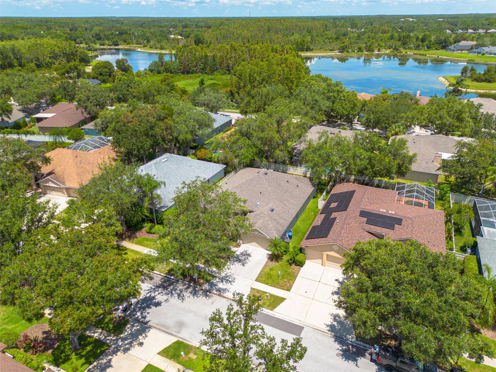 Discover your new home's prime location within the prestigious Hunter's Green community, beautifully nestled among mature oak trees and well-maintained neighborhoods. This aerial perspective showcases the privacy and tranquility that makes this location so desirable.