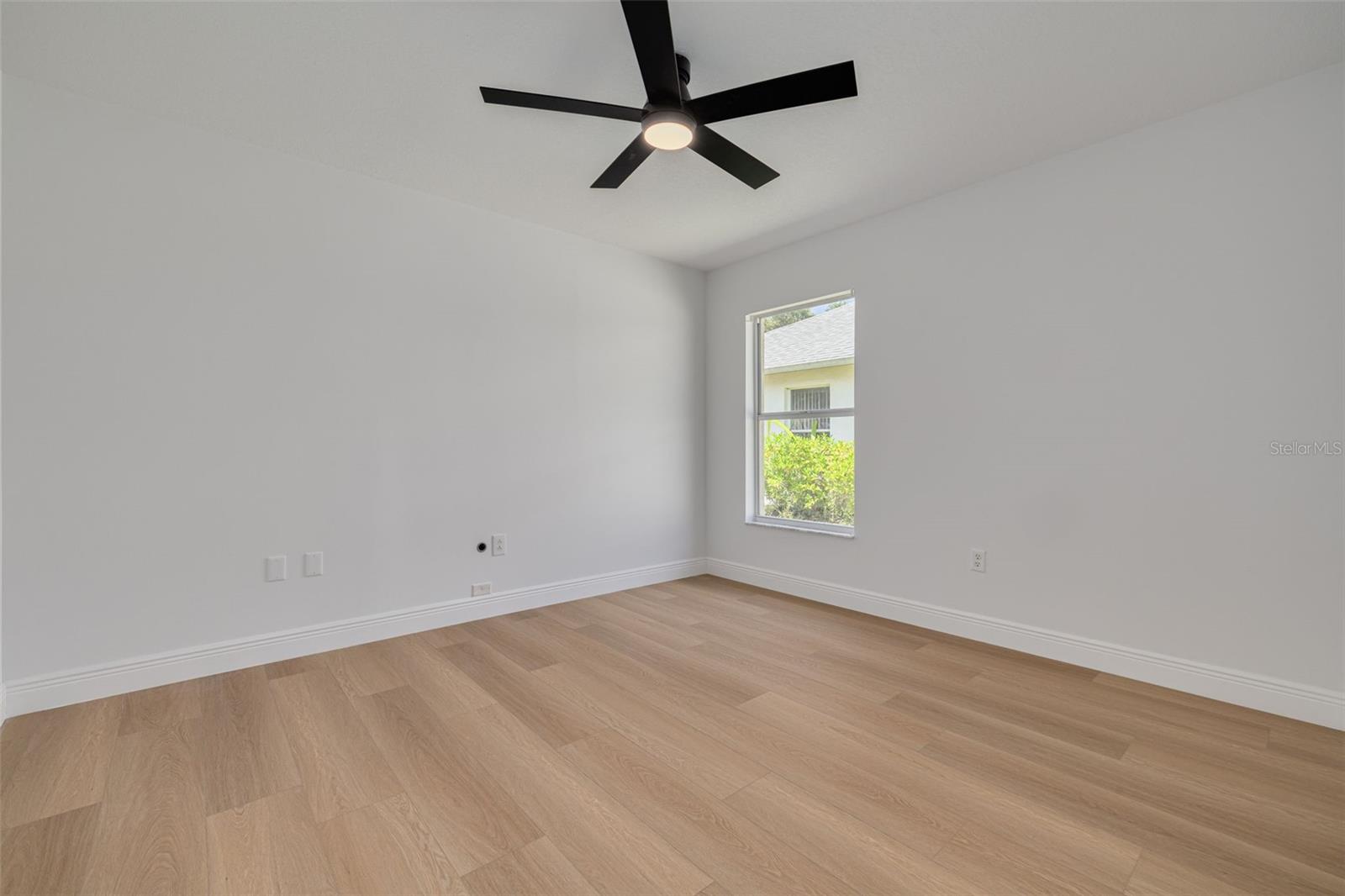 This versatile bedroom features convenient built-in closet storage and a new ceiling fan with lighting for comfort. The quality flooring and neutral paint colors make this space adaptable for any family's needs.