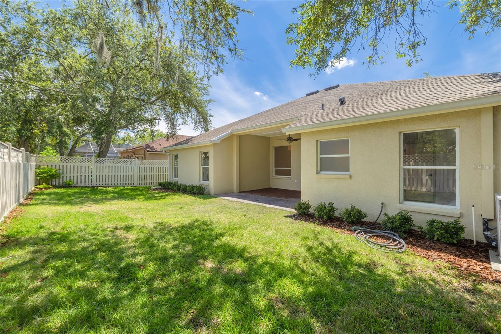 This spacious fenced backyard provides the perfect canvas for your outdoor dreams, whether it's adding a pool, creating gardens, or simply enjoying the Florida sunshine. The mature trees and privacy fencing create a peaceful retreat for family gatherings and outdoor entertainment.