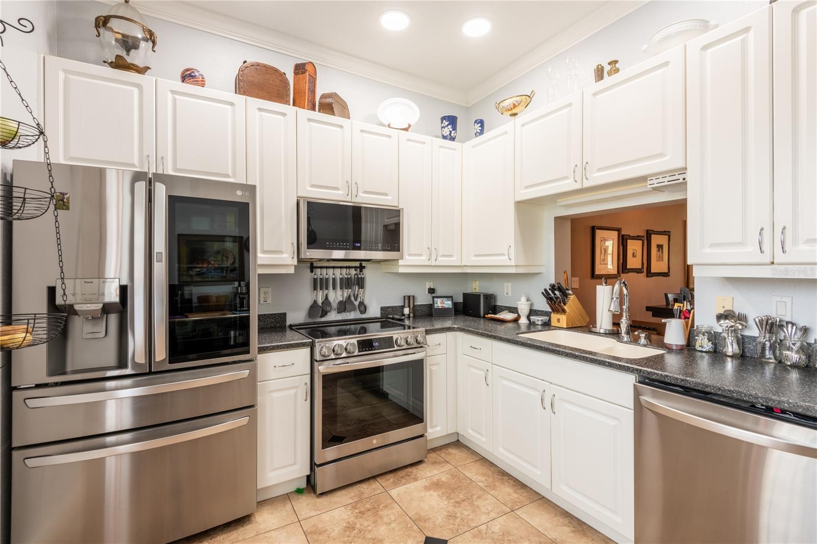 Beautiful upgraded appliances, counter top and a pass thru window to the dining/living room area.
