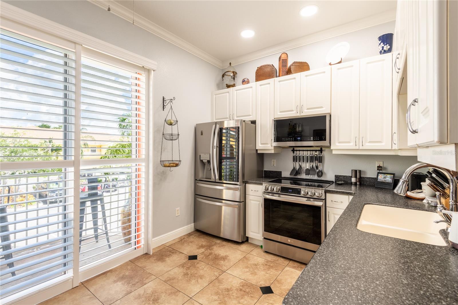 Bahama Shutters compliment the kitchen sliding glass doors to the open balcony.