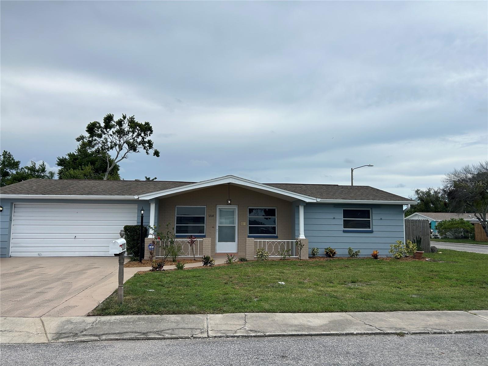 Large corner lot with porch, 2 car garage, fully fenced