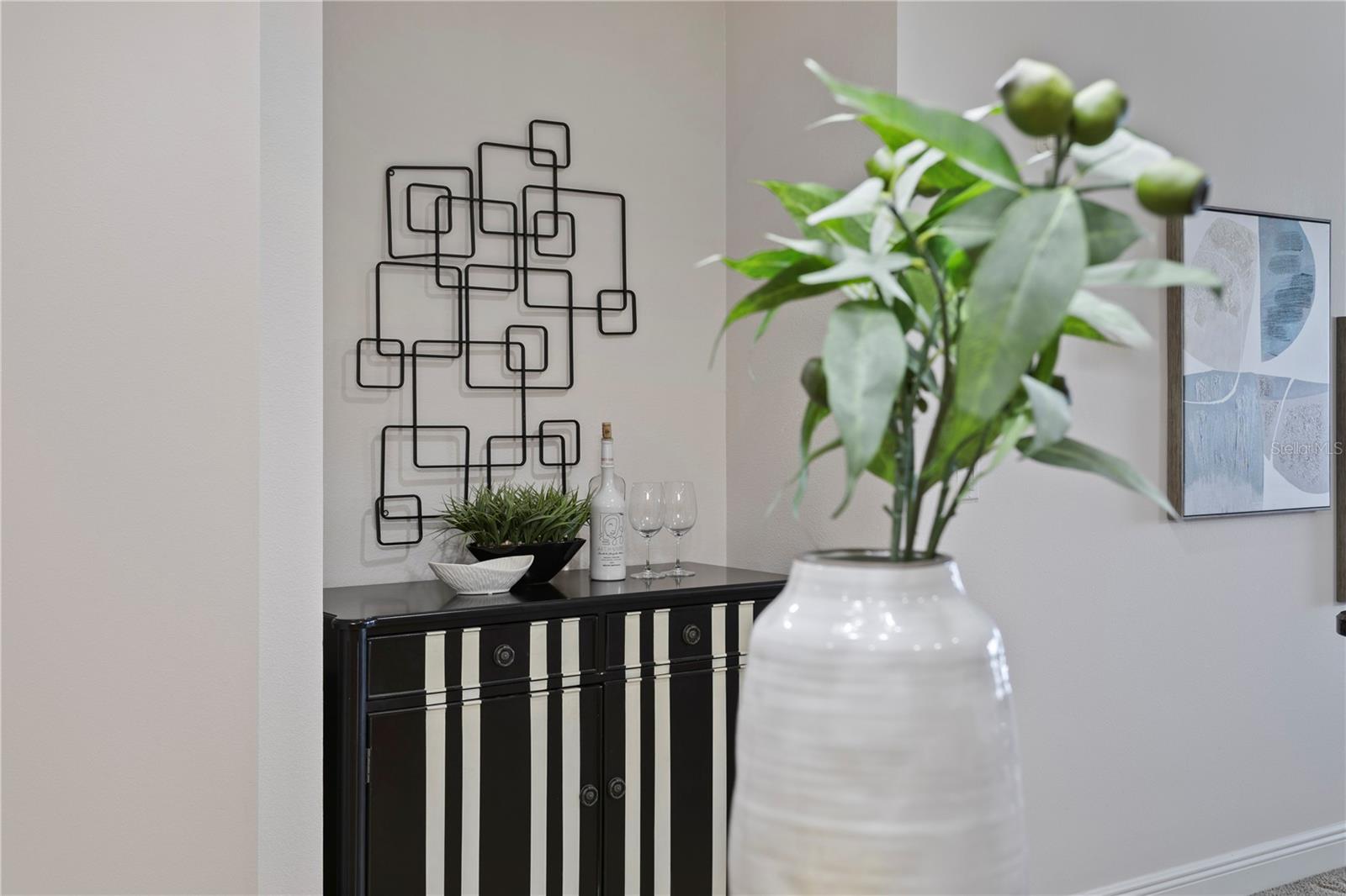 Alcove across from kitchen perfect for a striking accent piece, or use the power & water hook-up to build a wetbar