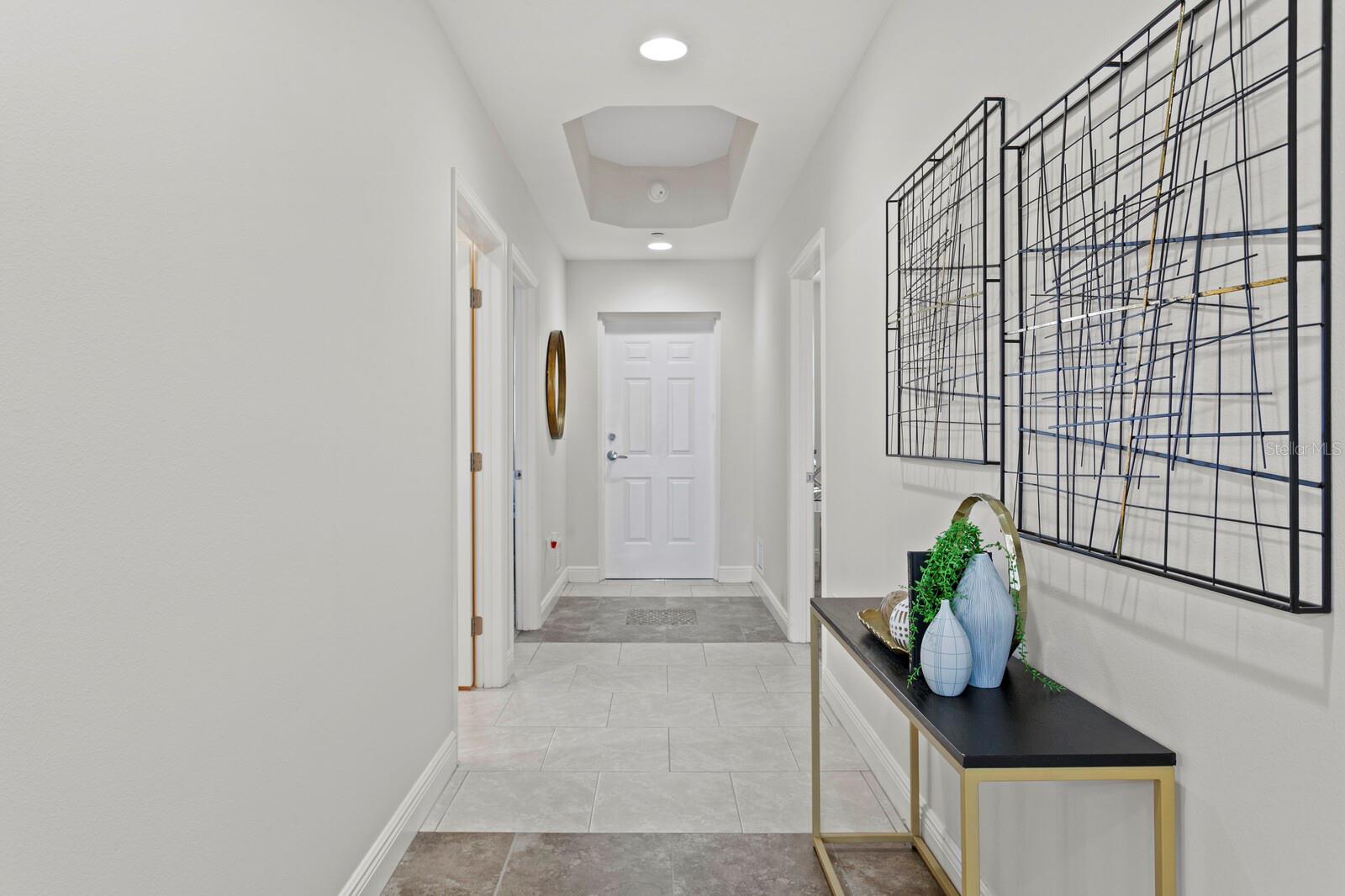 View looking toward front door. Laundry room right, kitchen on the left.