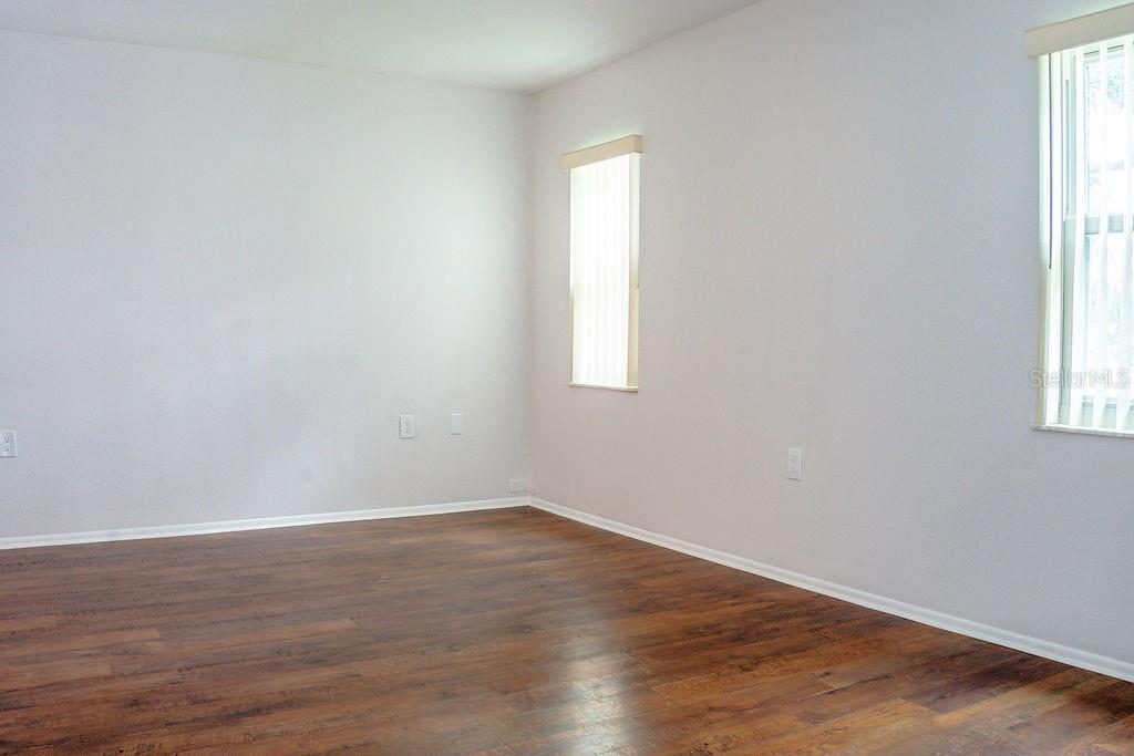 primary bedroom with new wood floors and hurricane windows