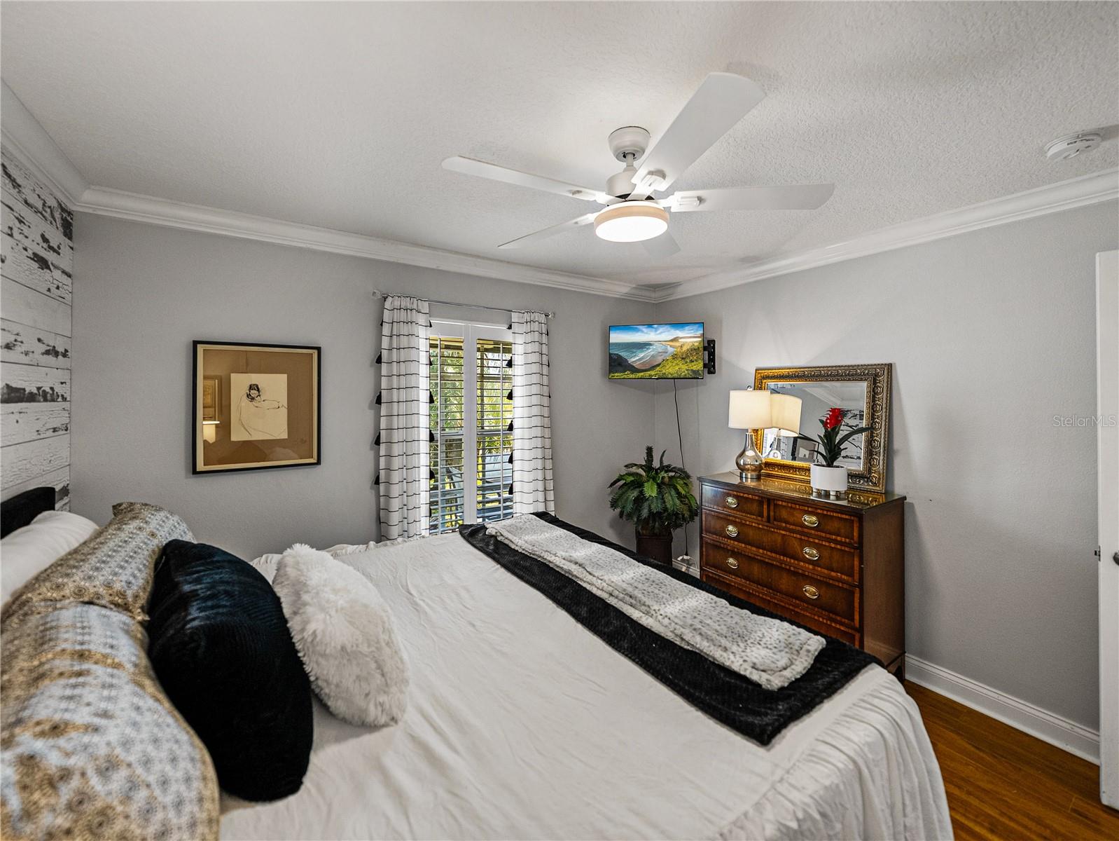 Third Bedroom with Wood Accent Wall and Views to Golf Course