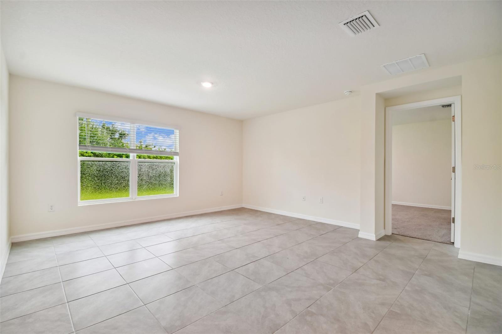 view of living area to primary room entry.