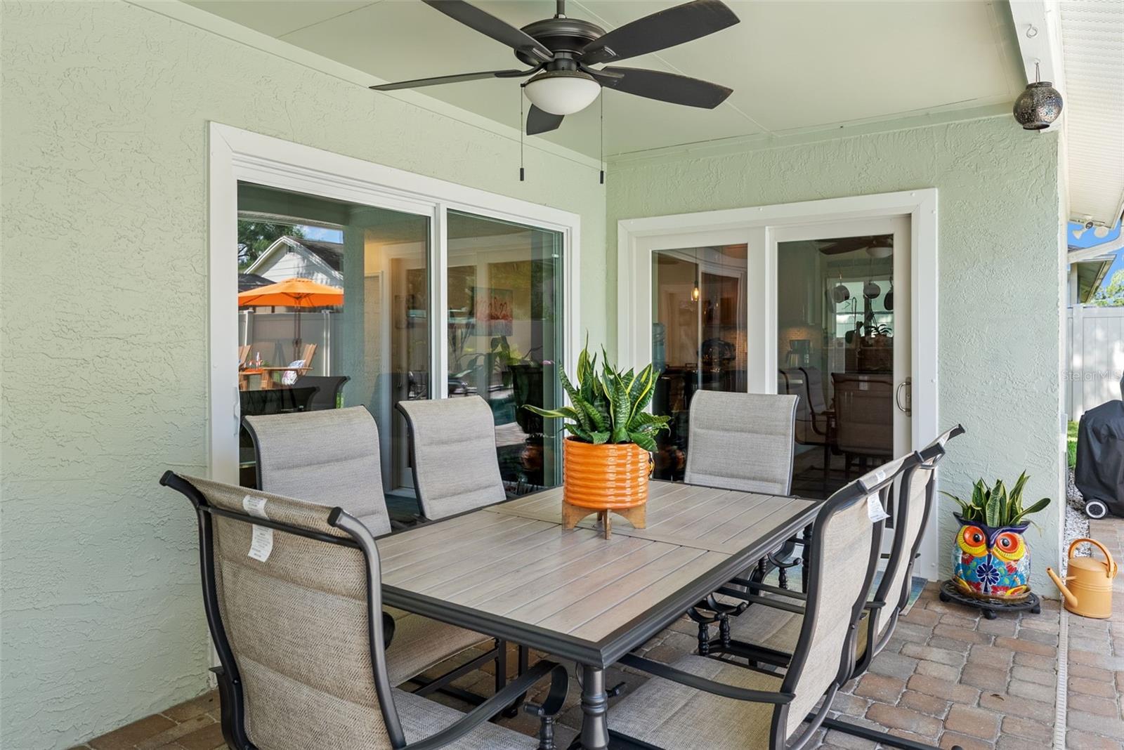 Patio lanai facing east has sliding glass doors to living room and French doors to kitchen