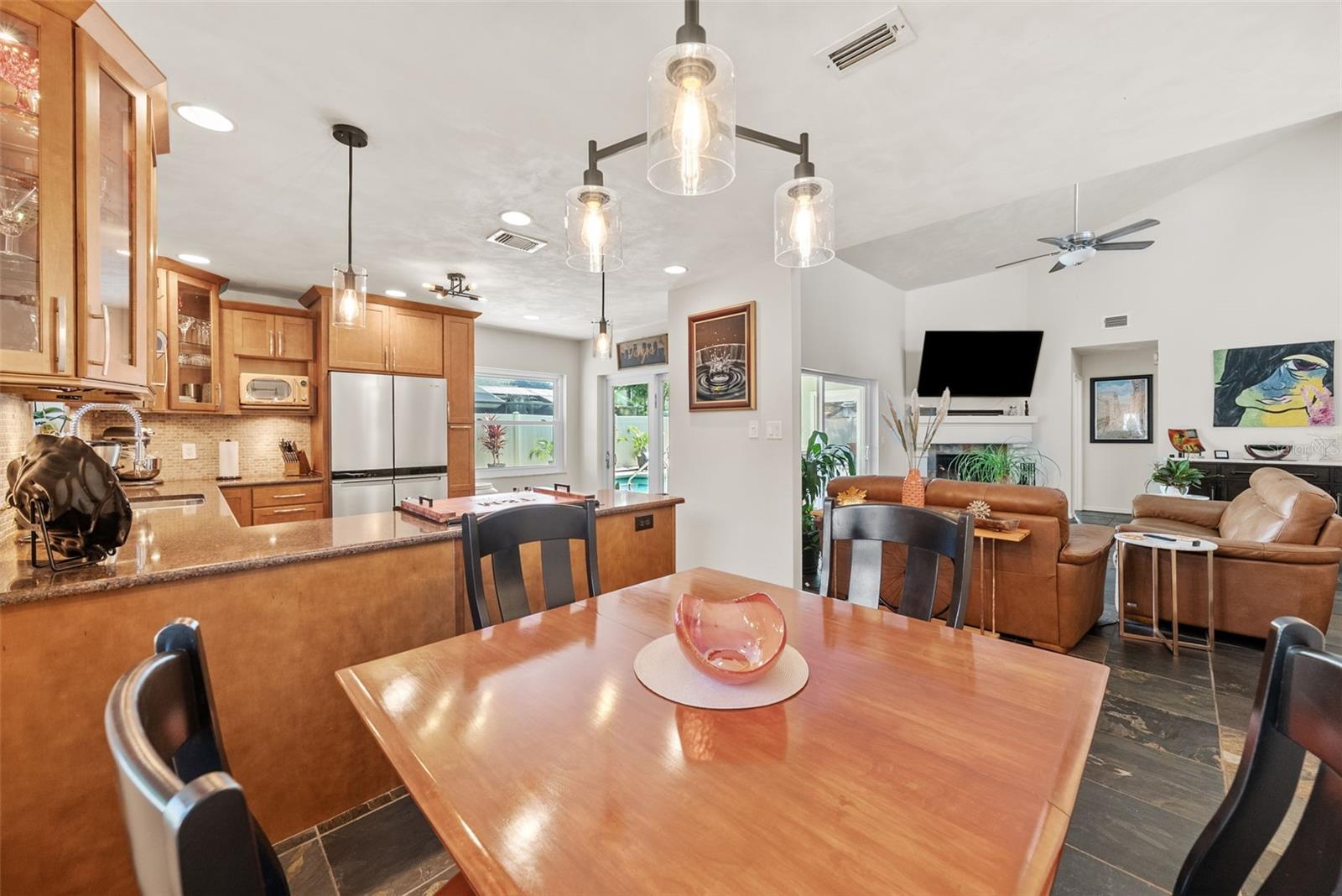 Dinette to kitchen with French doors leading to Lanai pool