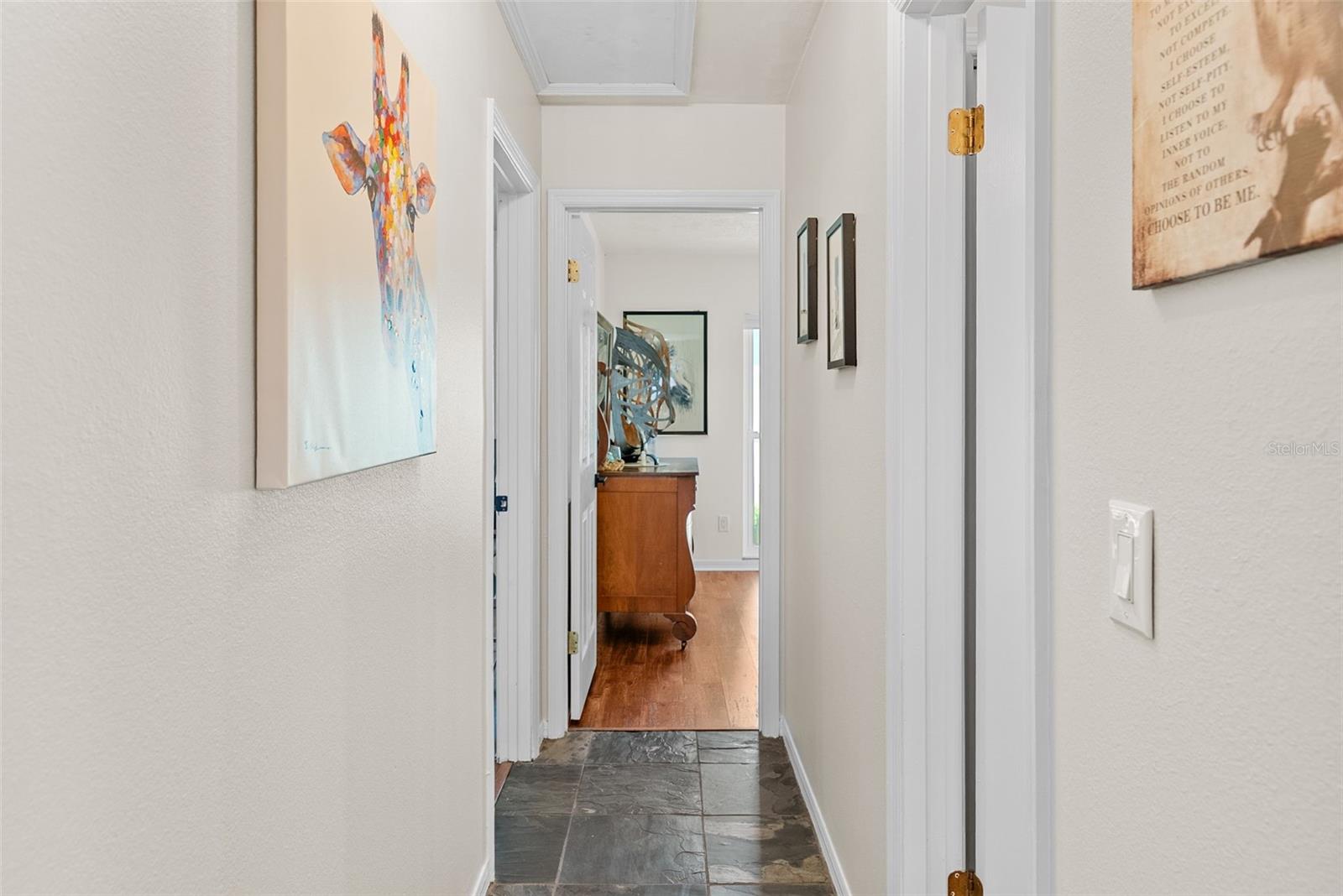 Hallway leading to two spare bedrooms off of kitchen on the other side of the home.