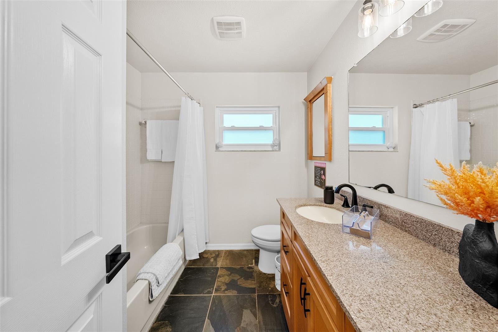 Full bath number two located off hallway from kitchen and living room, perfectly situated in between bedrooms two and three.