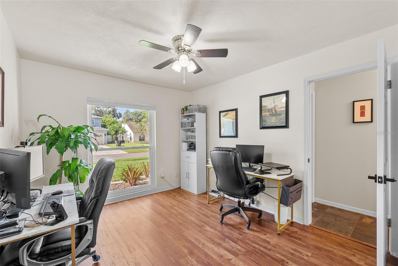 Bedroom number 3/office currently being used in that fashion has large front window to the exterior, a large closet and gorgeous luxury vinyl flooring.